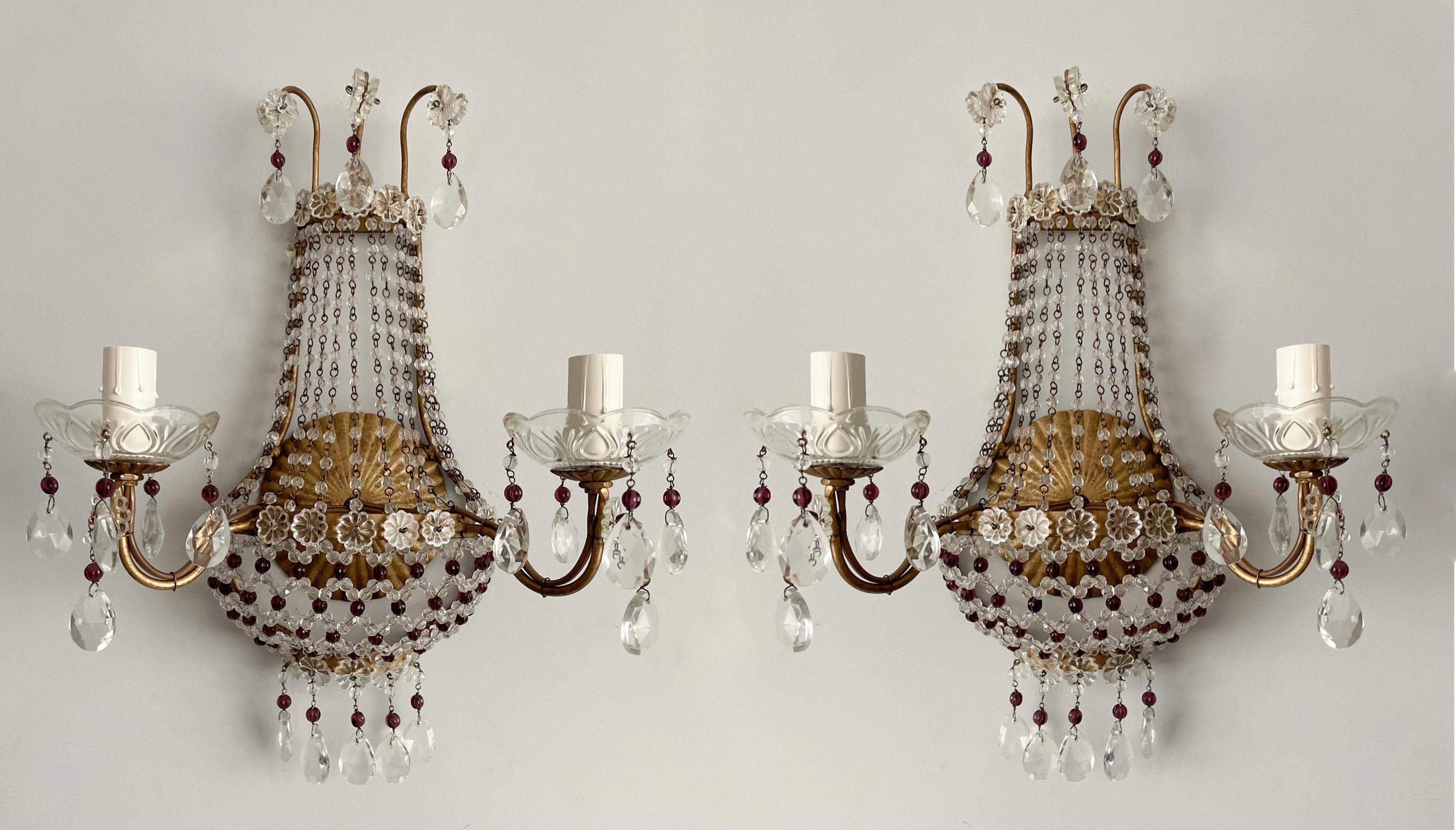 Exquisite, pair of Italian vintage crystal beaded sconces. 

Each sconce consists of a gilded-iron frame decorated with clear and amethyst glass beading. 

The sconces are wired and working condition, each requires 2 candelabra bulbs. 

This