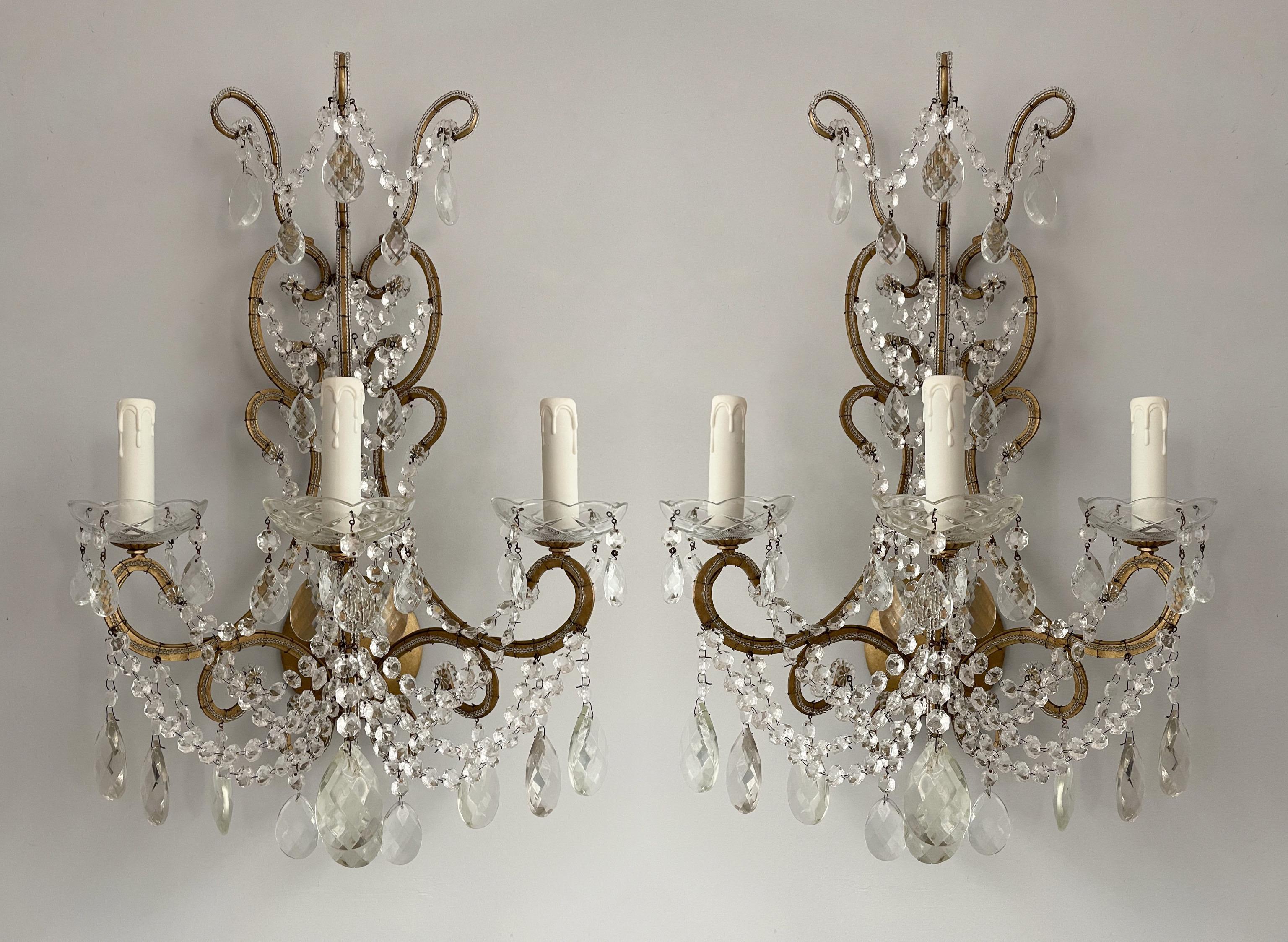 Beautiful, 1960s Italian gilt-iron and crystal beaded sconces. 

These sconces feature flat, scrolled iron frames in an antique gilded finish