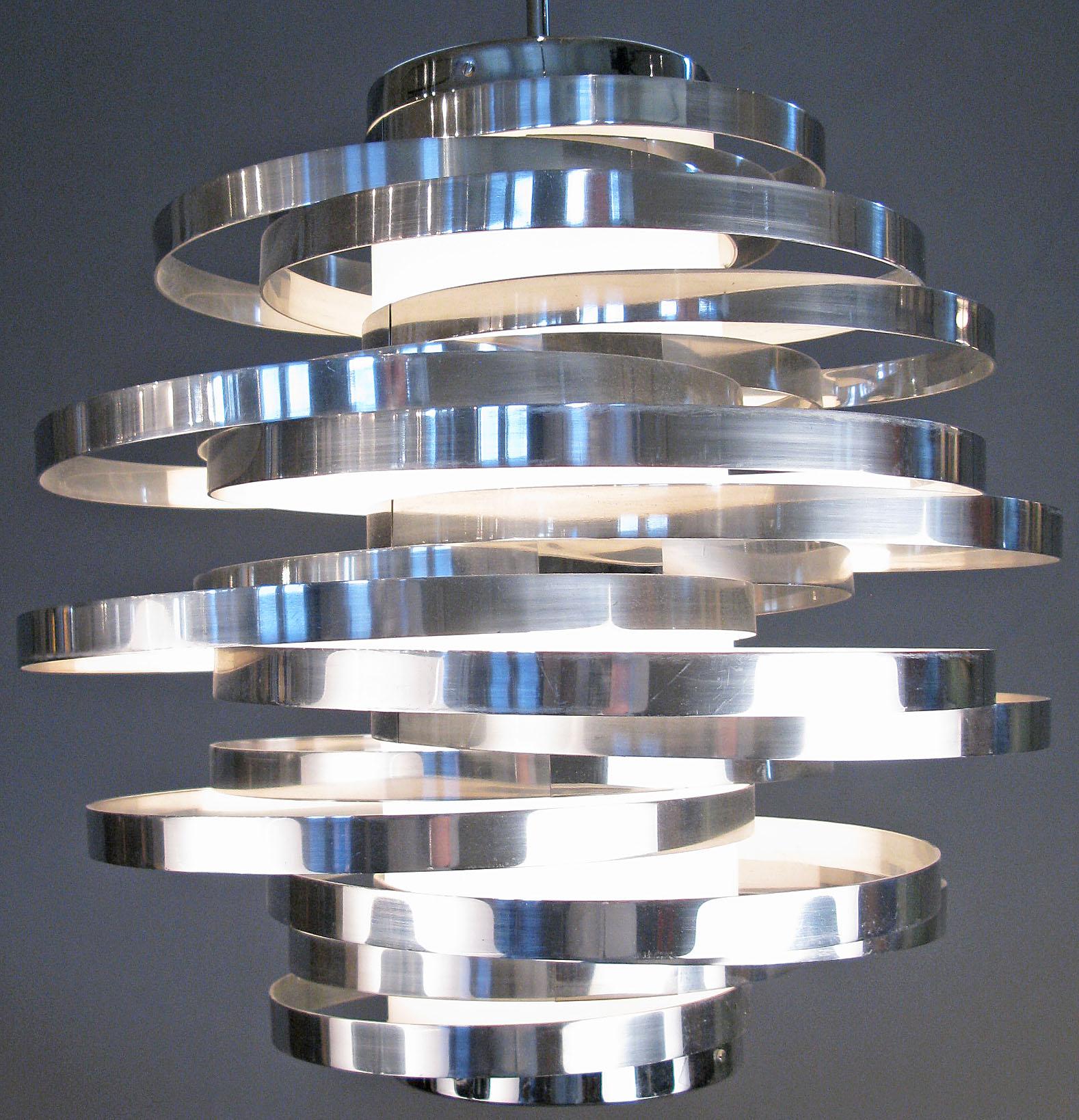 A stunning and dynamic vintage 1970's Italian hanging light designed by Max Sauze for Sciolari. one of his best designs, composed of a series of graduated bands of chromed steel, all attached to a central column of light, with the bands placed so