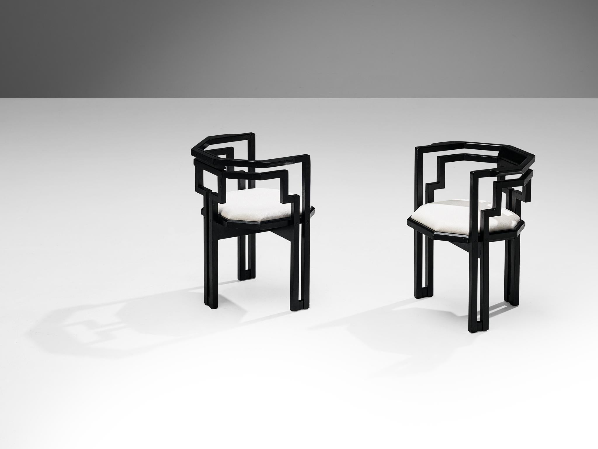 Pair of dining chairs, black lacquered oak, white fabric, Italy, 1970s.

Outstanding pair of geometric Italian dining chairs. These chairs combine a sculptural design that is simple, but very strong in lines and proportions with a luxurious feeling
