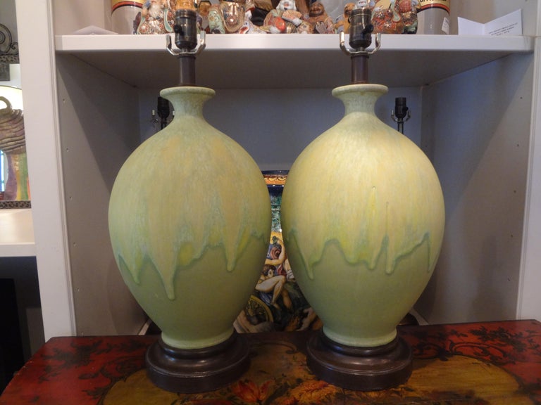 Pair of unusual Italian matte finish drip glazed ceramic lamps in a stunning shade of chartreuse. These beautiful lamps have been newly wired for the U.S. Market with new sockets.