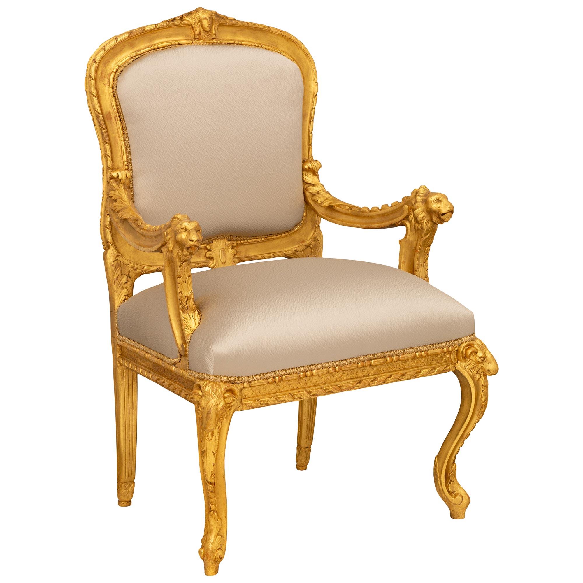 An extremely decorative pair of Italian early 18th century Baroque period Giltwood armchairs. Each wonderfully detailed armchair is raised on front cabriole legs displaying stunning acanthus leaf and twisted ribbon carvings leading to bold rams