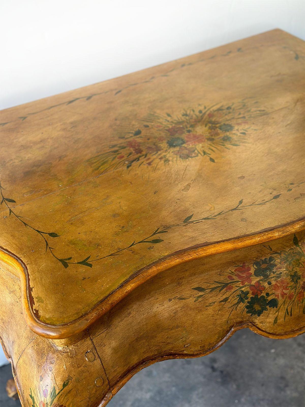 Early 19th Century pair of wooden consoles in bombé form with hand-painted floral depictions around each piece.
Dimensions:
35.5