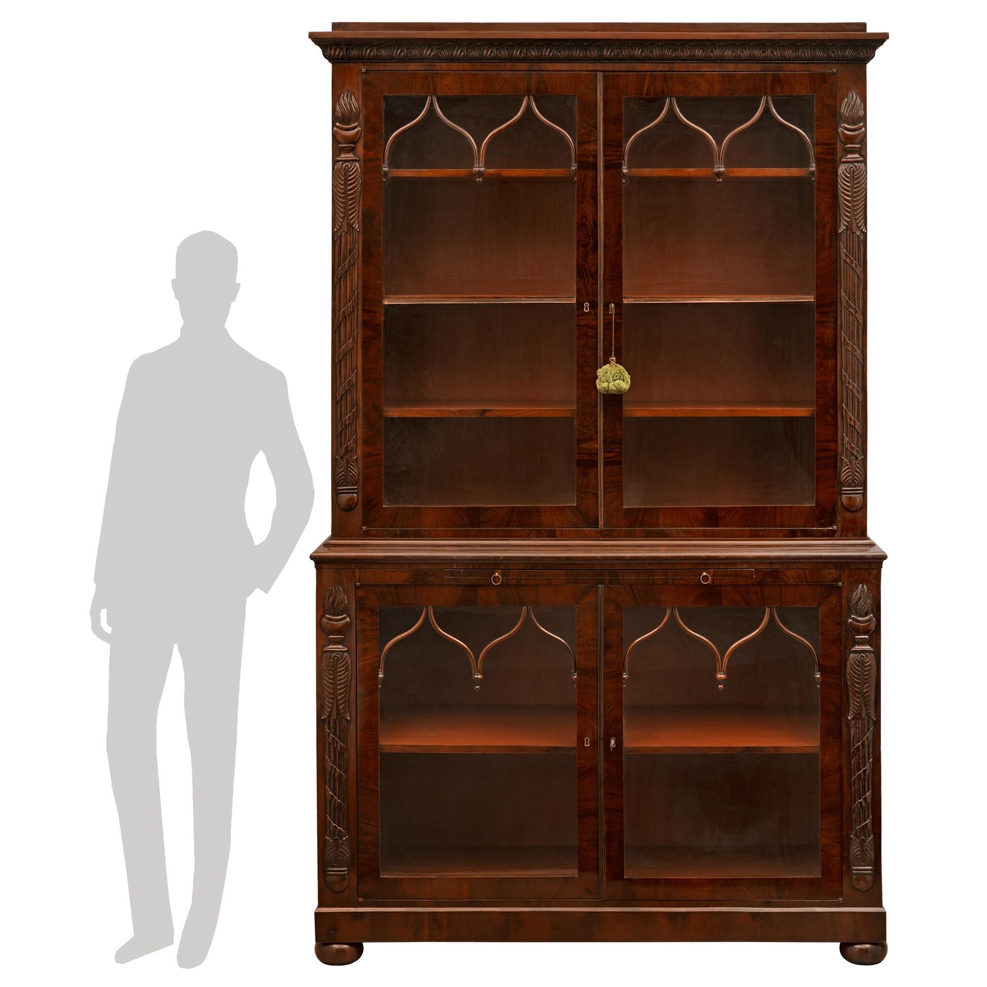 A spectacular and rare pair of Italian early 19th century, circa 1810, First Empire Period vitrines. Each crouch mahogany vitrine is raised on bun feet below two sets of double cabinet doors with the original hand blown inserted glass and original
