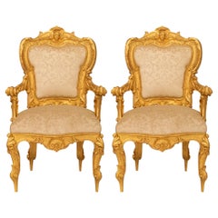 pair of Italian early 19th century Louis XV st. Giltwood armchairs