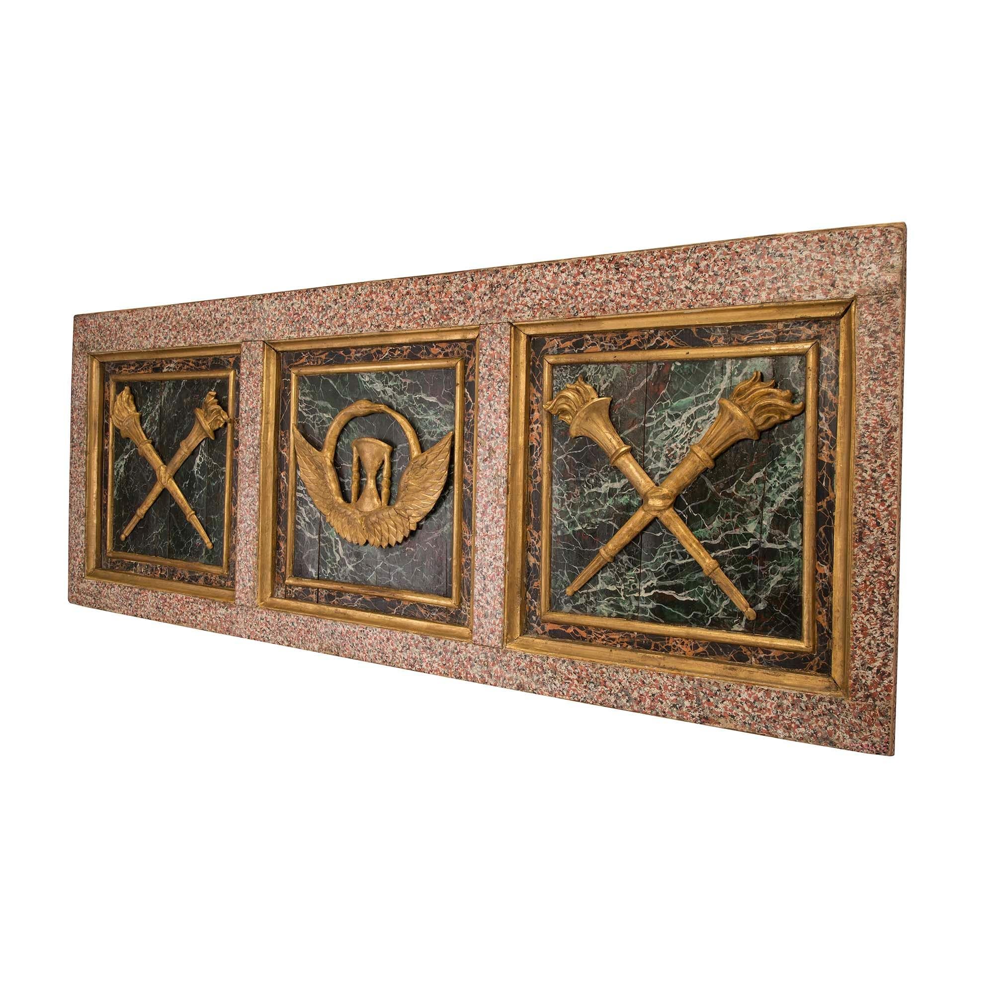 An extremely decorative pair of Italian early 19th century Louis XVI st. faux marble and giltwood wall panels. Each panel displays a wonderfully executed faux granite border with three central recessed squares. Each square is framed within a fine
