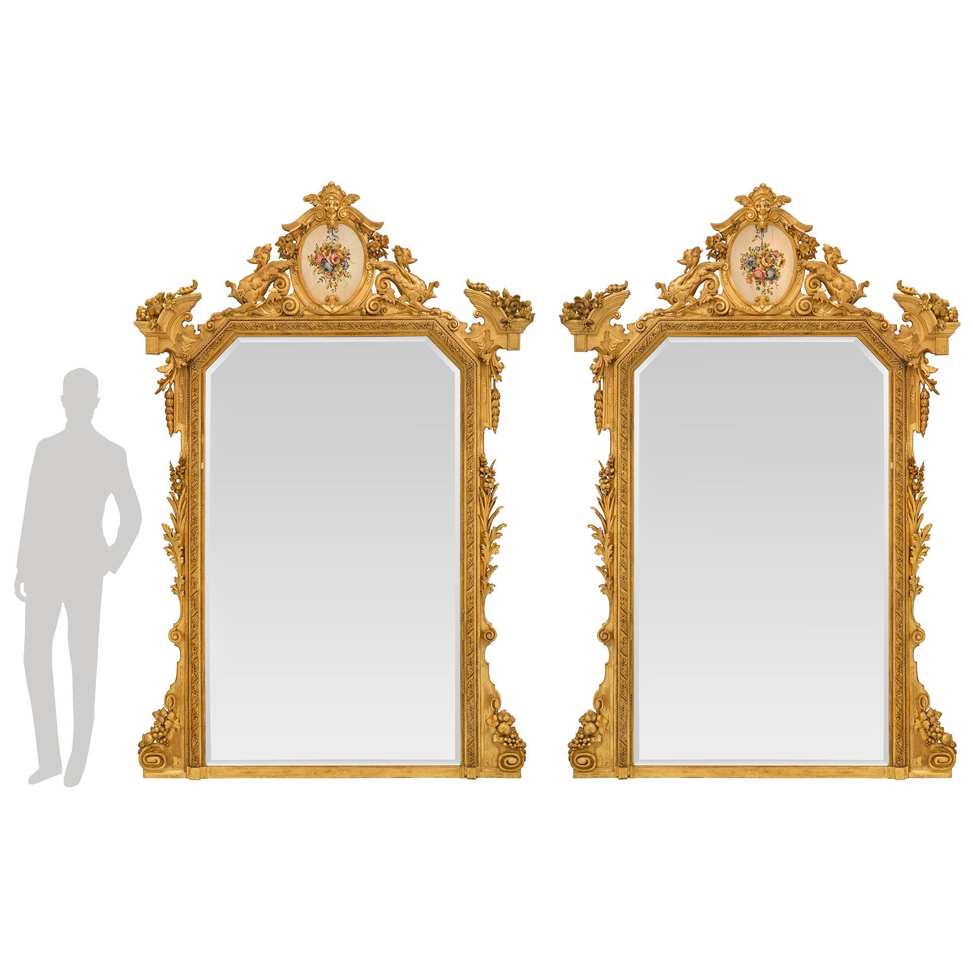 A magnificent and monumentally scaled pair of Italian early 19th century st. giltwood mirrors from the Lombardi region. Each mirror retains its original mirror plate set within a most elegant mottled frame with finely detailed Les Oves patterns,