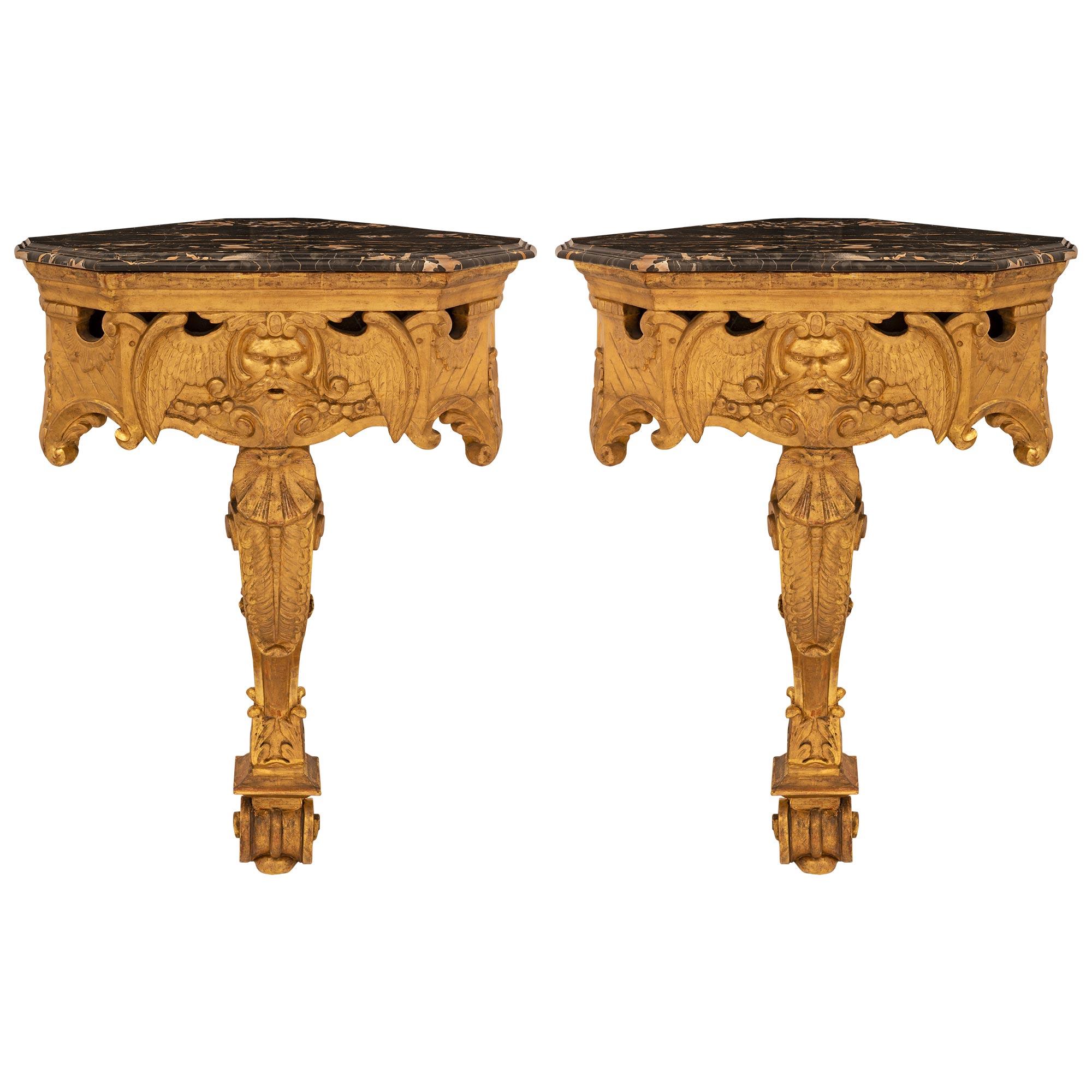 An impressive and exceptionally decorative pair of Italian early 19th century Baroque st. giltwood and Portoro marble consoles/planters. Each wall mounted console is raised by a striking single scrolled support with beautiful feet and adorned in