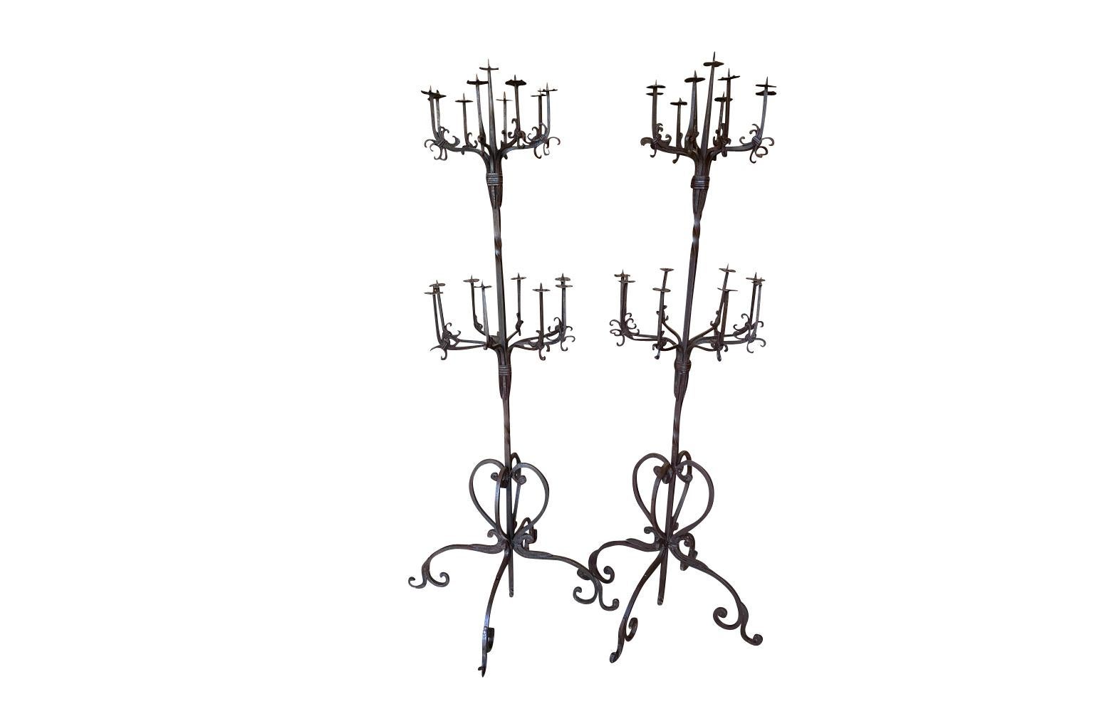 A very lovely early-20th century Italian Torcheres in beautifully crafted iron. Both measure 73 1/2