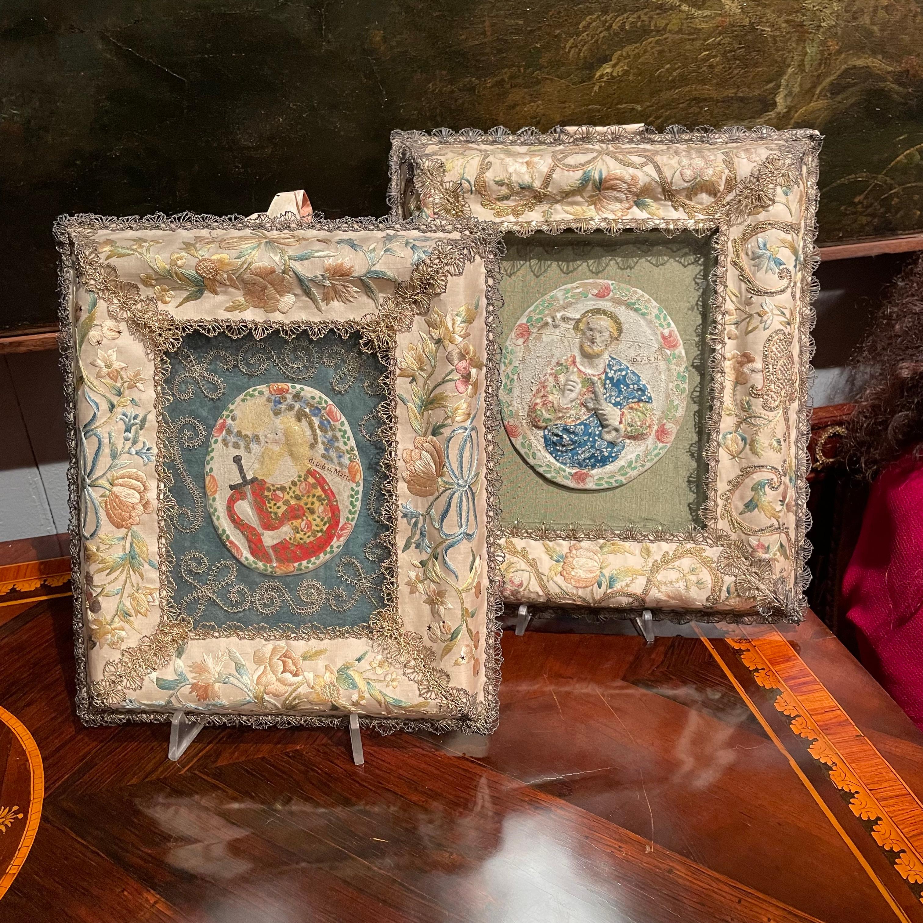 Pair of antique embroidered frames, rectangular shape, in ivory colored silk satin with embroidery in cotton and gold lamé of floral elements and love knots. These are devotional monastic Italian artworks dating back to the second half of the 1700s,