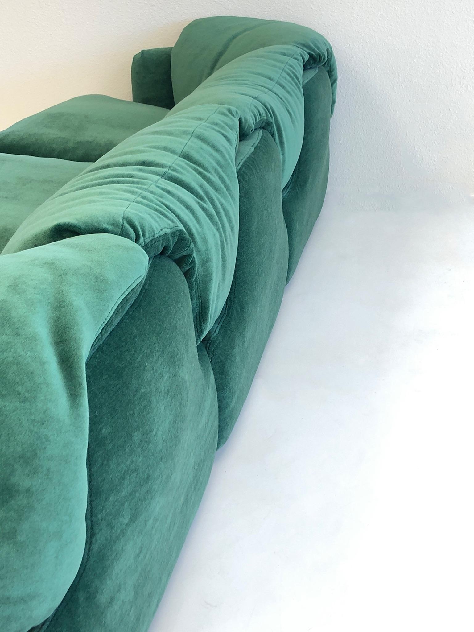 A spectacular pair of Italian “Confidential” sofas designed by Alberto Rosselli for Saporiti I the 1970s. The sofas have been newly recovered in a soft emerald green mohair fabric. The base on the sofas is black plastic. Both sofas retain Saporiti