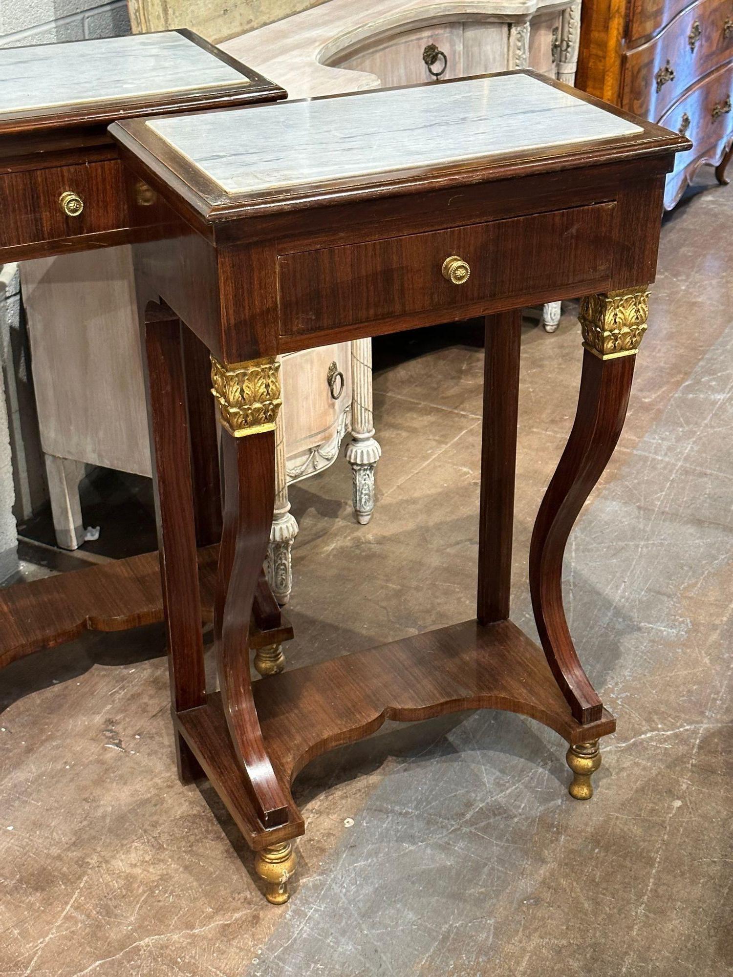 Nice pair of Italian Empire style mahogany and gilded marble top side tables. Circa 1880. Adds warmth and charm to any room!