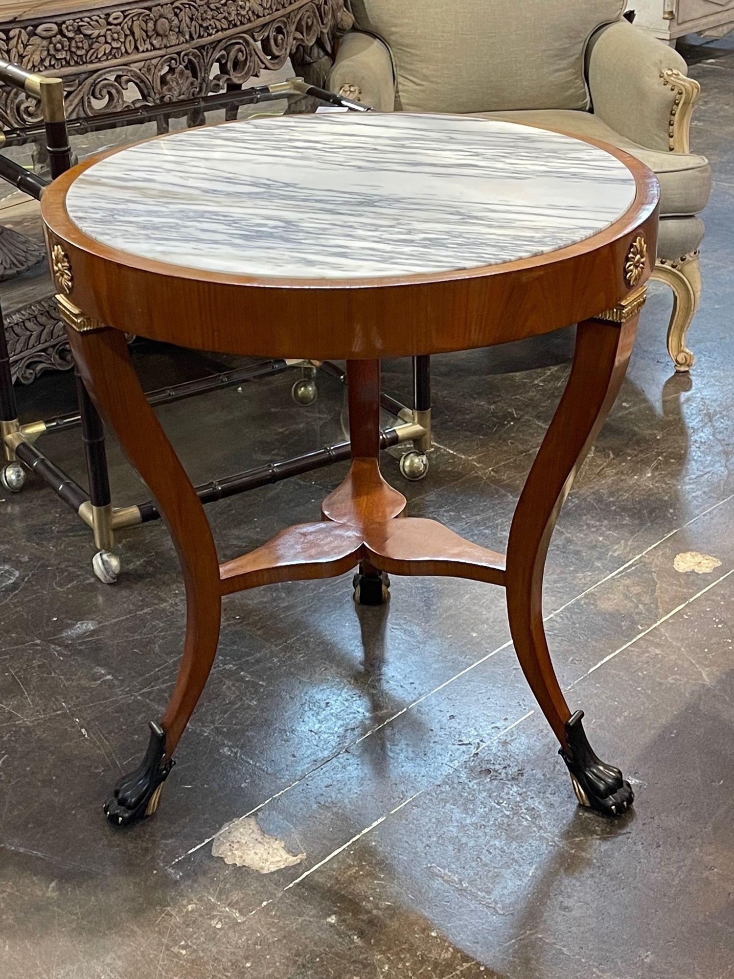 Stylish pair of Italian Empire style walnut and ebonized side tables. These also have beautiful inlaid marble, gilt details and claw feet. Creates a lovely upscale look! 