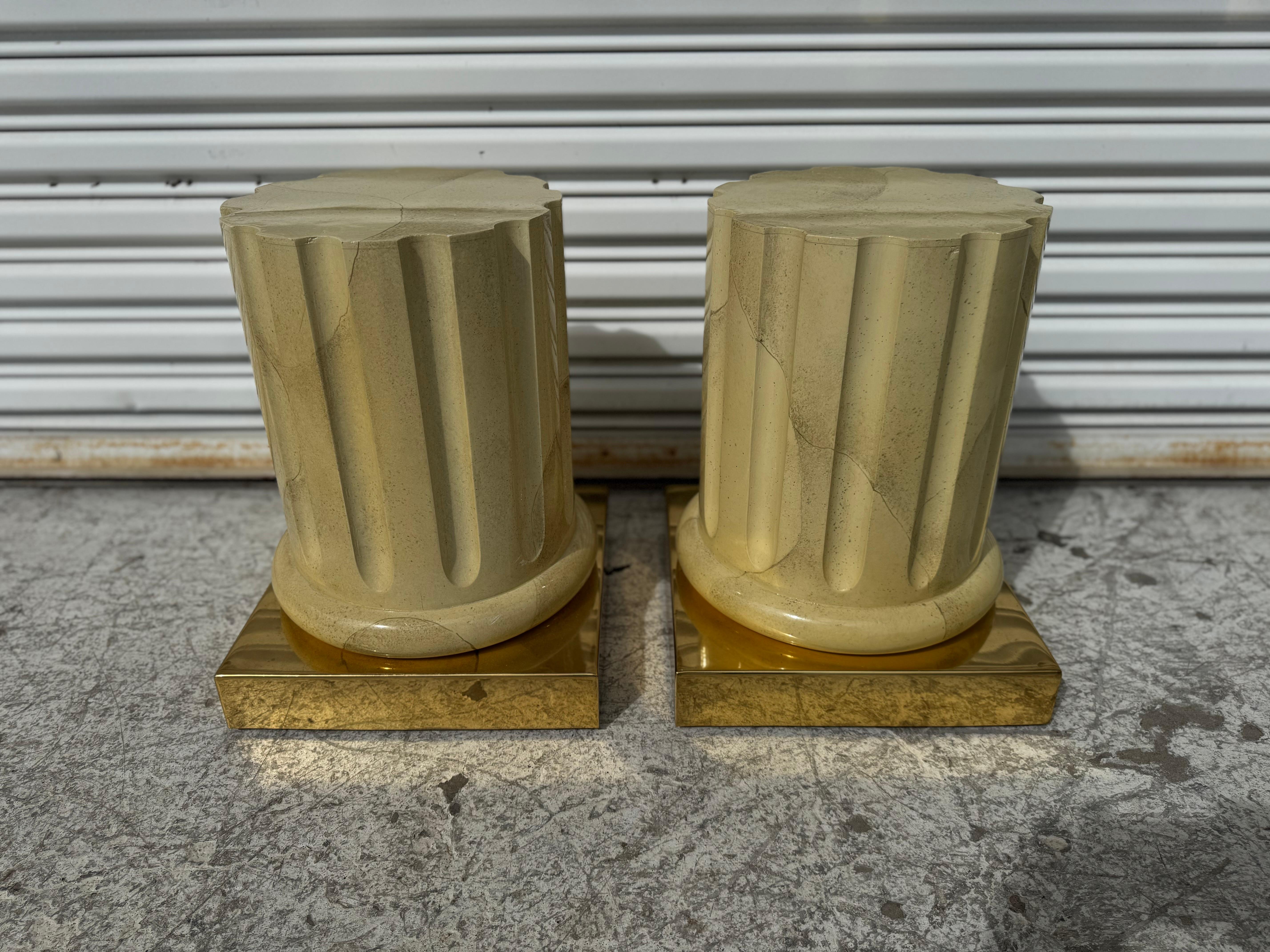 This pair of end tables or coffee table is made in Italy.
The bases are shaped like Roman columns centered in brass.
They give the appearance of goatskin but are faux.
A rectangular large piece of glass can easily make these bases into a coffee
