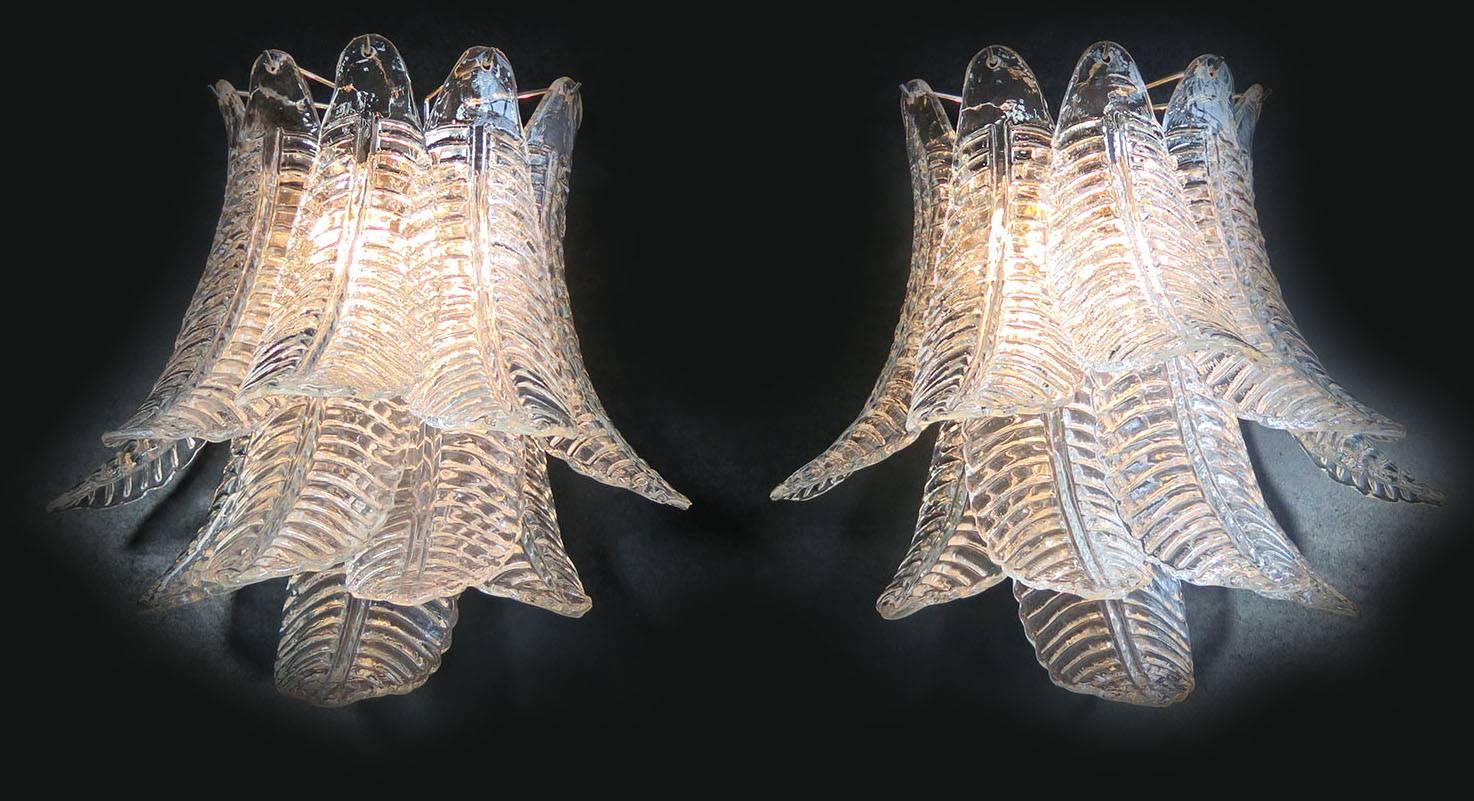 Fantastic pair of vintage Murano wall sconce made by ten Murano transparent six-tier felci for each applique
in a chrome metal frame.
Dimensions: 18.50 inches height (47 cm); 18.50 inches width (47 cm); 13 inches depth from the wall (33