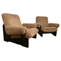 Used Pair of Italian fireside chairs from the 70s. Wooden structure. Original fabric.