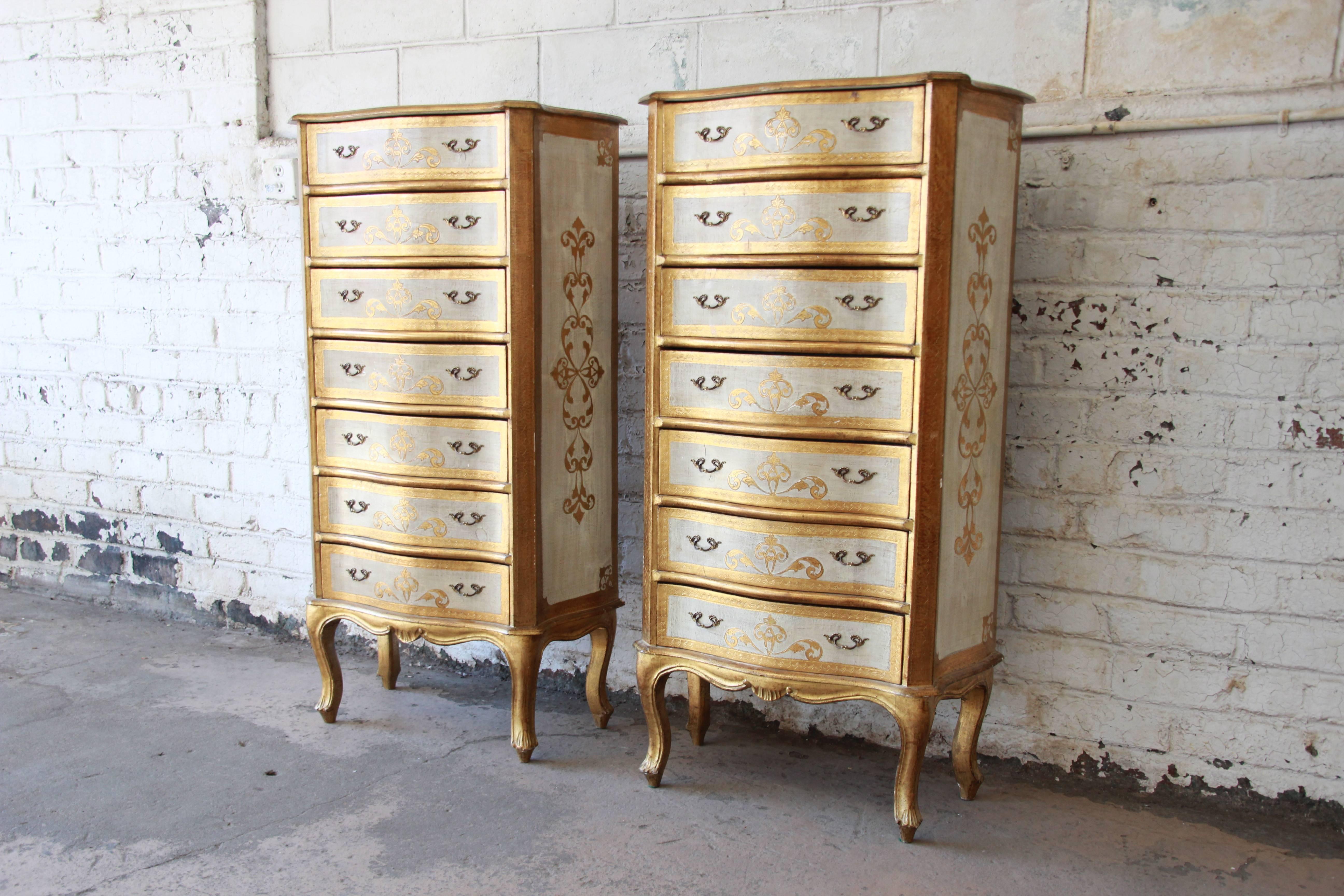 A gorgeous pair of 1940s Italian Florentine gold gilt and cream lingerie chests or semainiers. The chests feature stunning carved details and great storage, each with seven drawers. They are sturdy and well made. There is some patina and wear to