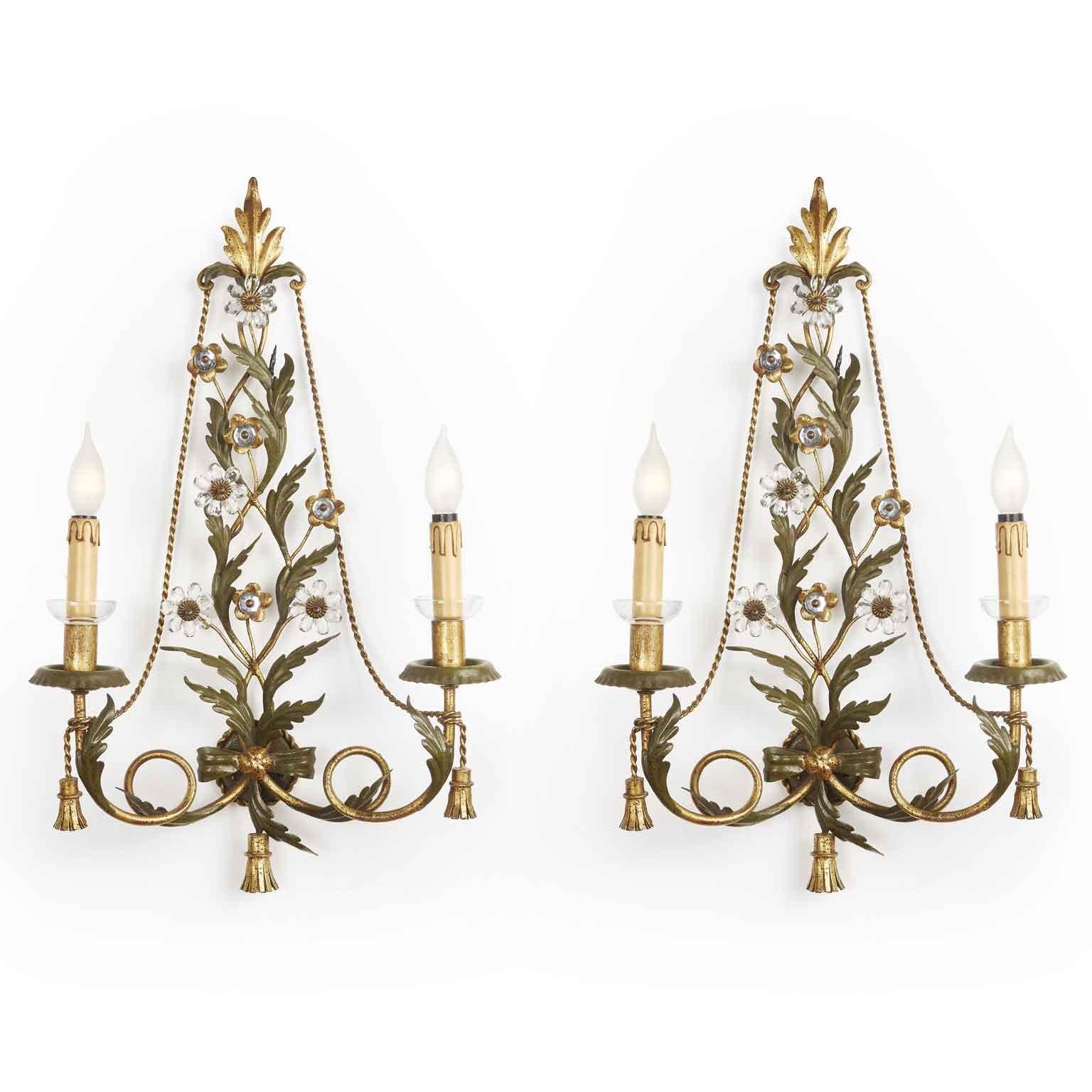 From Italy a Florentine vintage pair of sconces, two olive green painted and partially gilt two-light iron sconces by Banci, manufactured by Banci Firenze, decorated with crystal flowers. 
These original Italian iron wall-lights are realized with a
