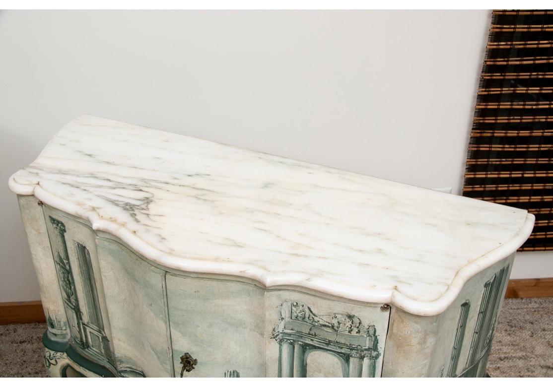 Pair of midcentury double door marble-topped commodes with hand painted illustrations of Pompeiian ruins in green scale paint. Each commode comes with a key and an interior shelf.
Measures: 39 1/2