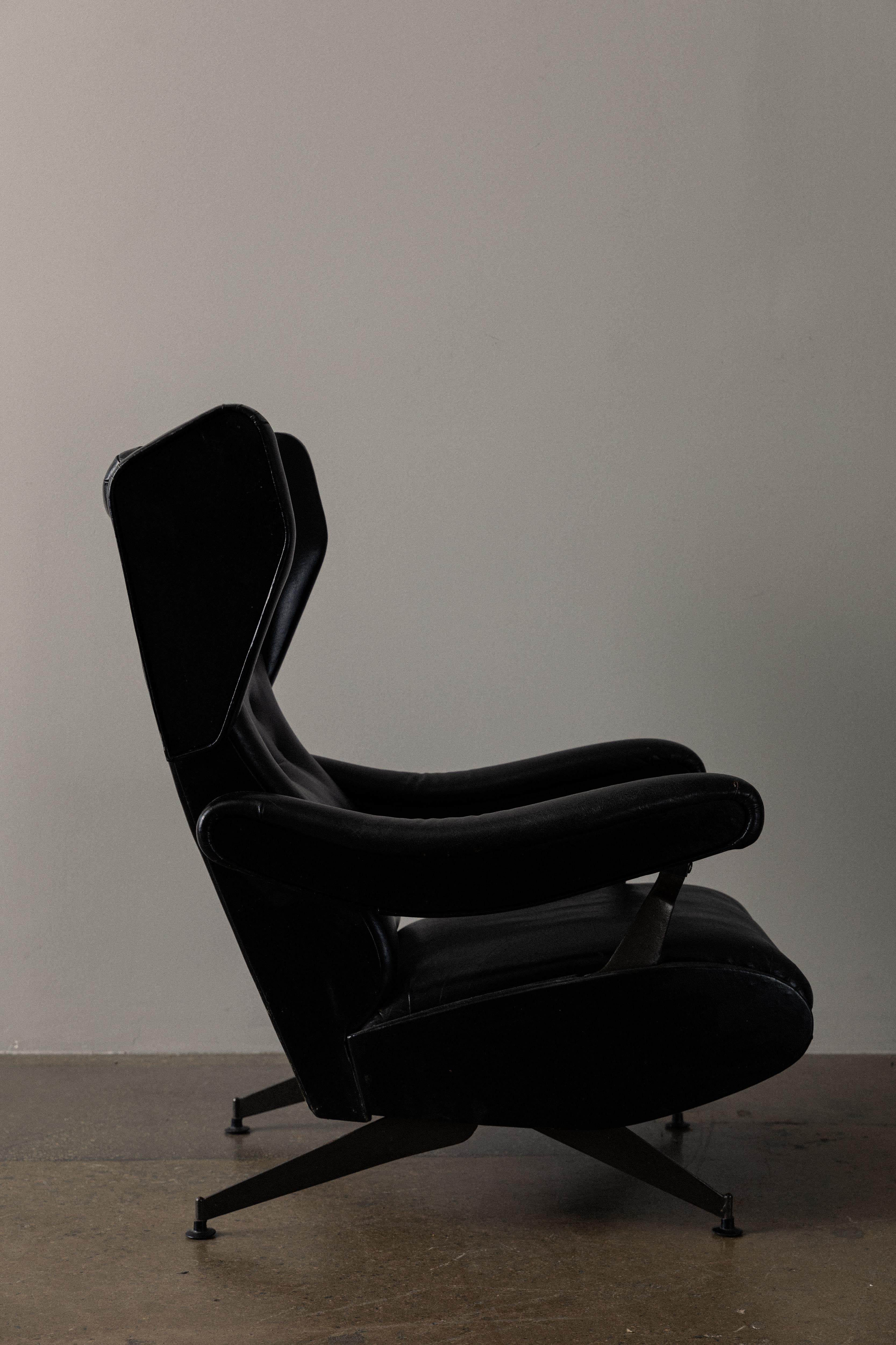 Pair of unique, sculptural wingback chairs with reclining options. Black leather in great condition. Labels on bottom of chair.