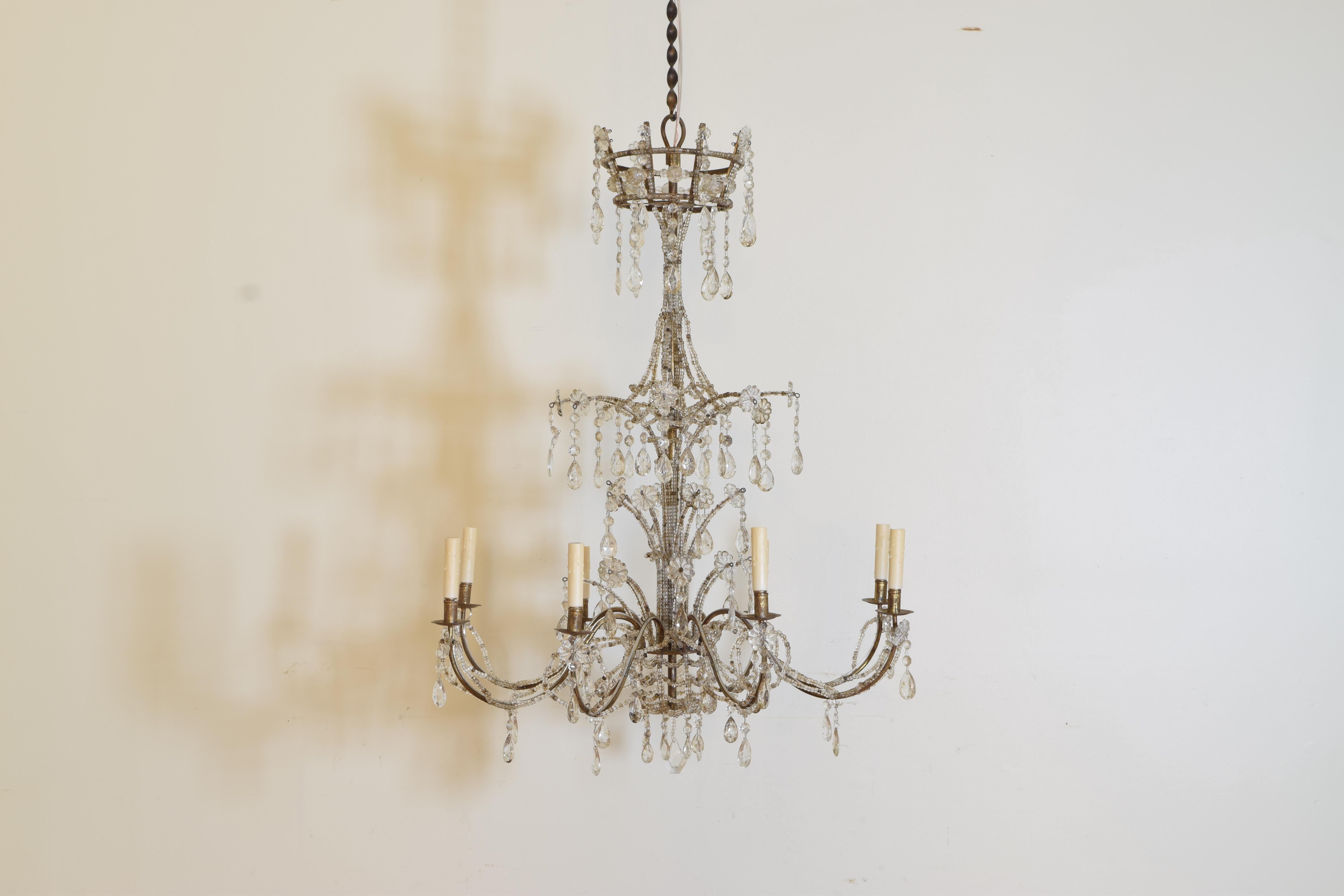 A highly stylish pair of Mid Century Genovese chandeliers having a cage form top above standard issuing arms with faceted prisms, the body of the chandelier covered in tight glass bead chain.
