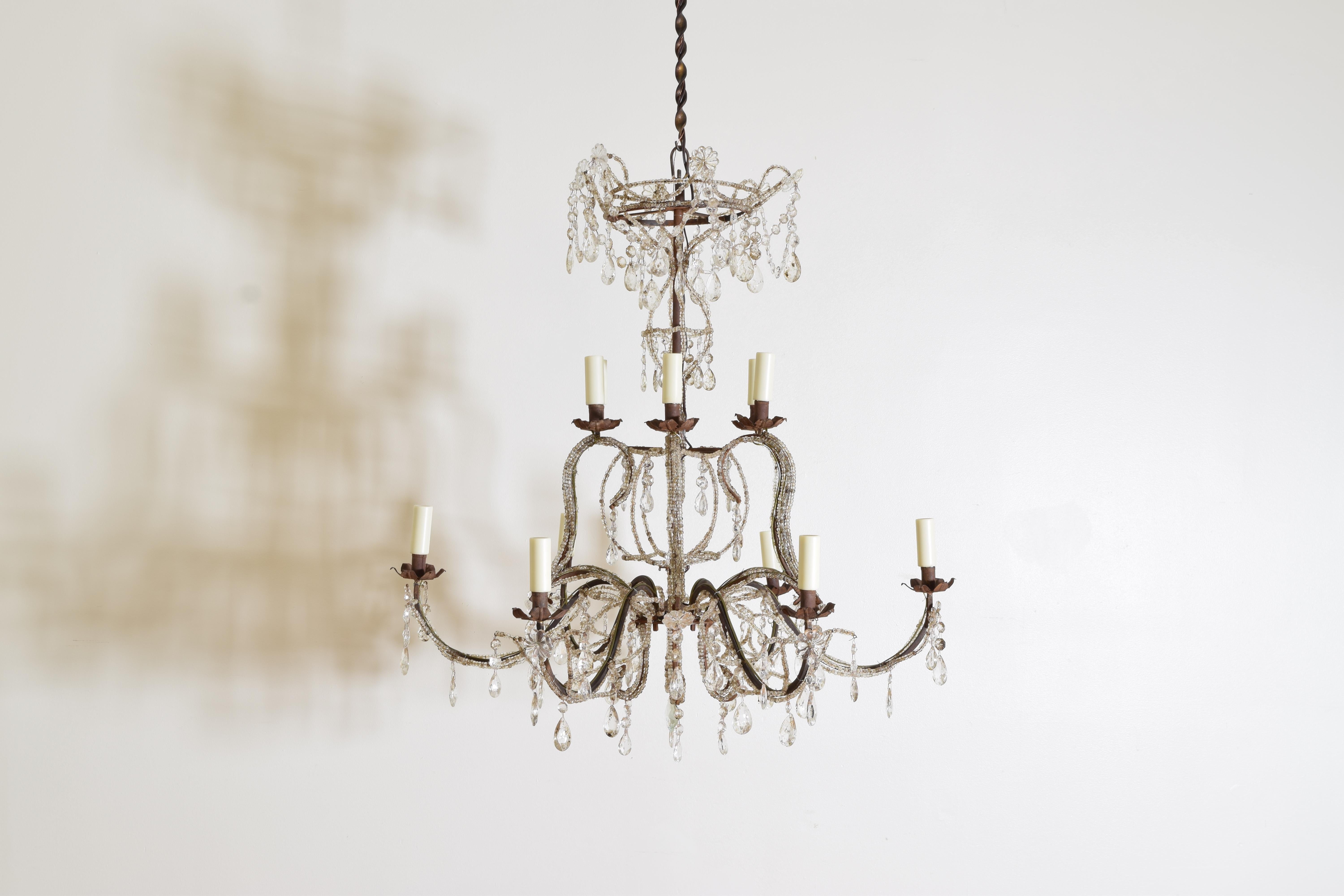 Twelve lights and two-tiered Crystal and Gilt Metal Chandeliers from Genoa, Italy, circa 1960s.