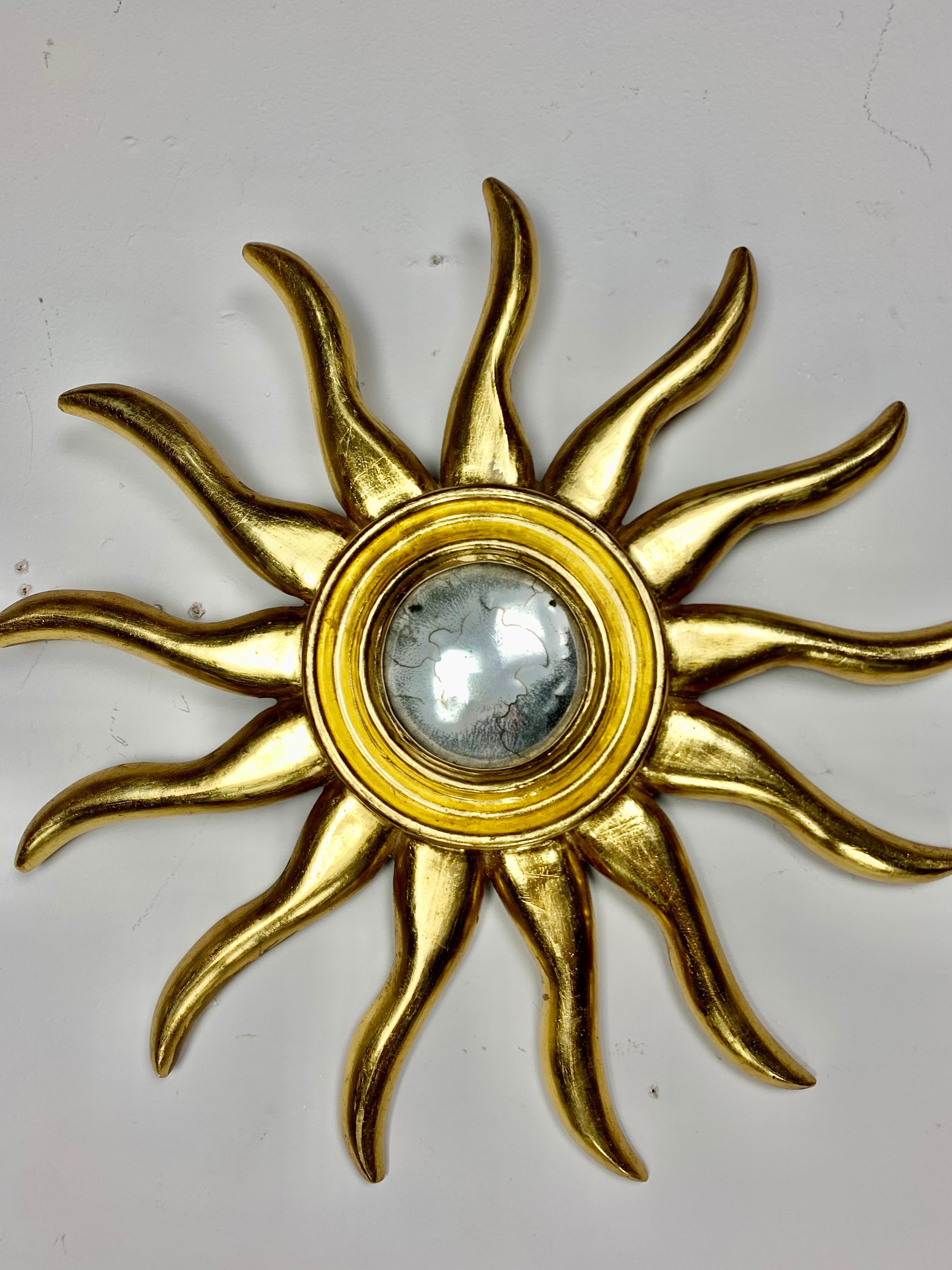 Pair of Italian carved giltwood sunburst mirrors. They are a great accent over windows and doorways or add a few more for a special wall covered with sunshine. I have my own wall and enjoy it everyday.