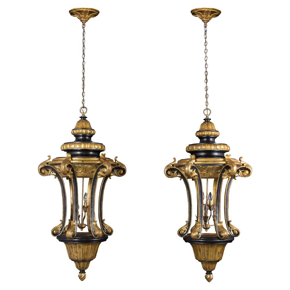 A vintage pair of Italian gilt lanterns handcrafted out of solid wood and features finely carved details throughout the entire pieces and elegant giltwood and ebonized finish combination. The lanterns come with six lights in the center wired to US