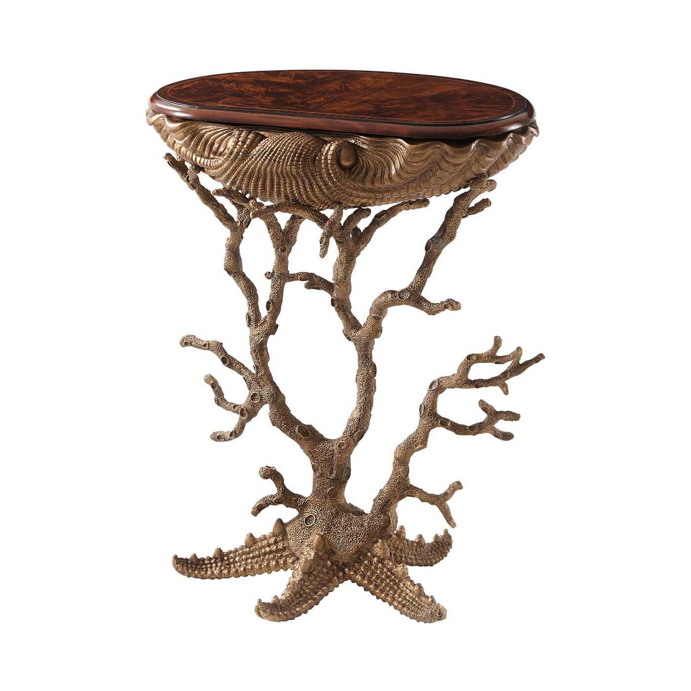 An unusual pair of Grotto tables, the rounded 'D' shaped flame mahogany and rosewood crossbanded top above a gilt metal cast base of a giant clamshell supported by coral legs issuing from a starfish. Inspired by Renaissance shell-decorated