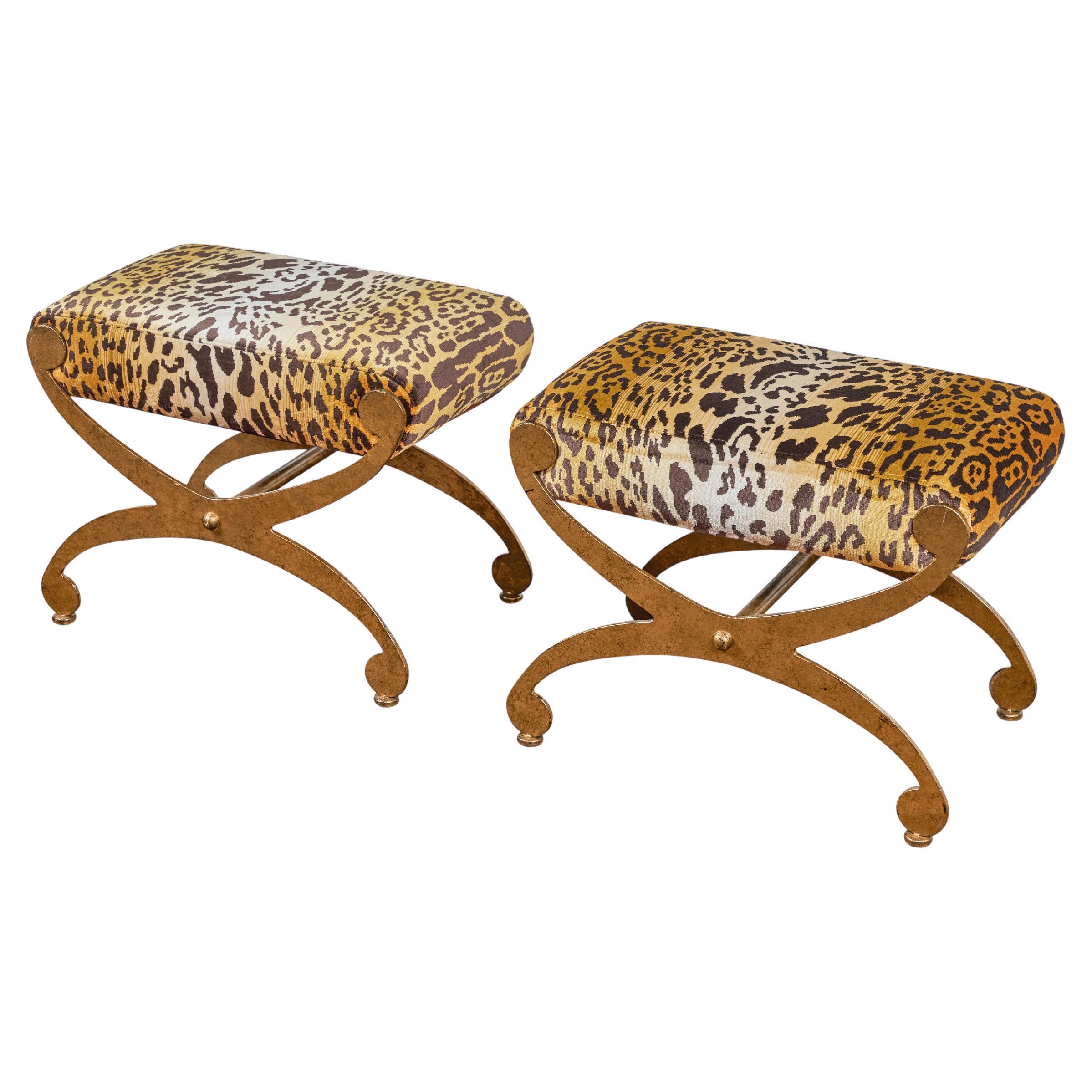 Wonderful and versatile pair of gilt metal benches newly re-upholstered in a spectacular leopard fabric by Nobilis France.  These benches are well made and very heavy.  they would be incredibly chic in an entry, flanking a console table or floating