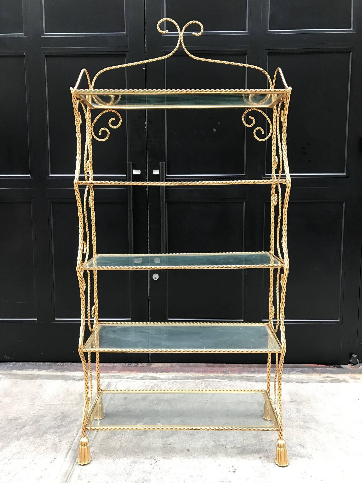 Pair of Italian gilt metal rope and tassel etageres with five glass shelves.