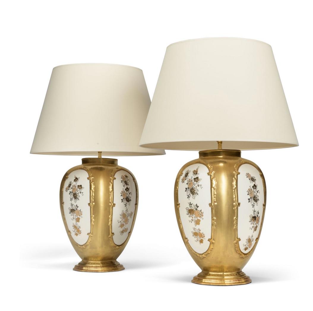 A superb pair of Italian designed porcelain vases, each with beautifully gilded floral panels on a white background with gilt ground bodies. Now mounted as table lamps with hand-gilded bases.

Height of vases:  17 3/4 in (45 cm) including bases, but