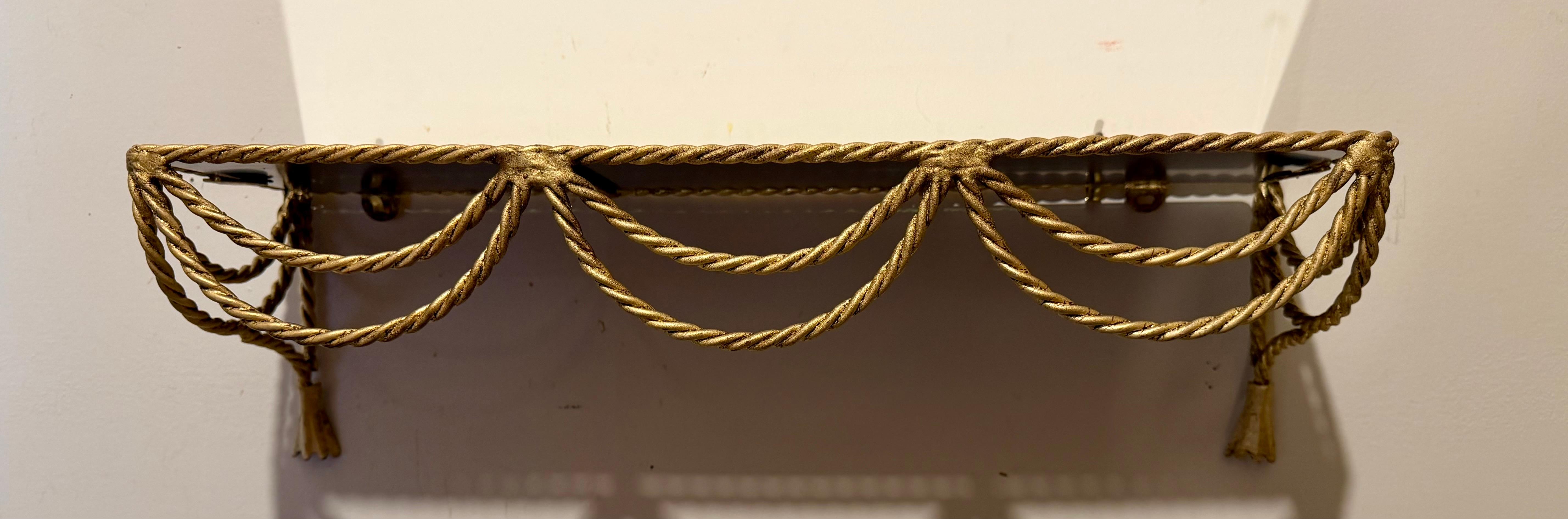 Glass Pair Of Italian Gilt Rope And Tassel Wall Shelves For Sale