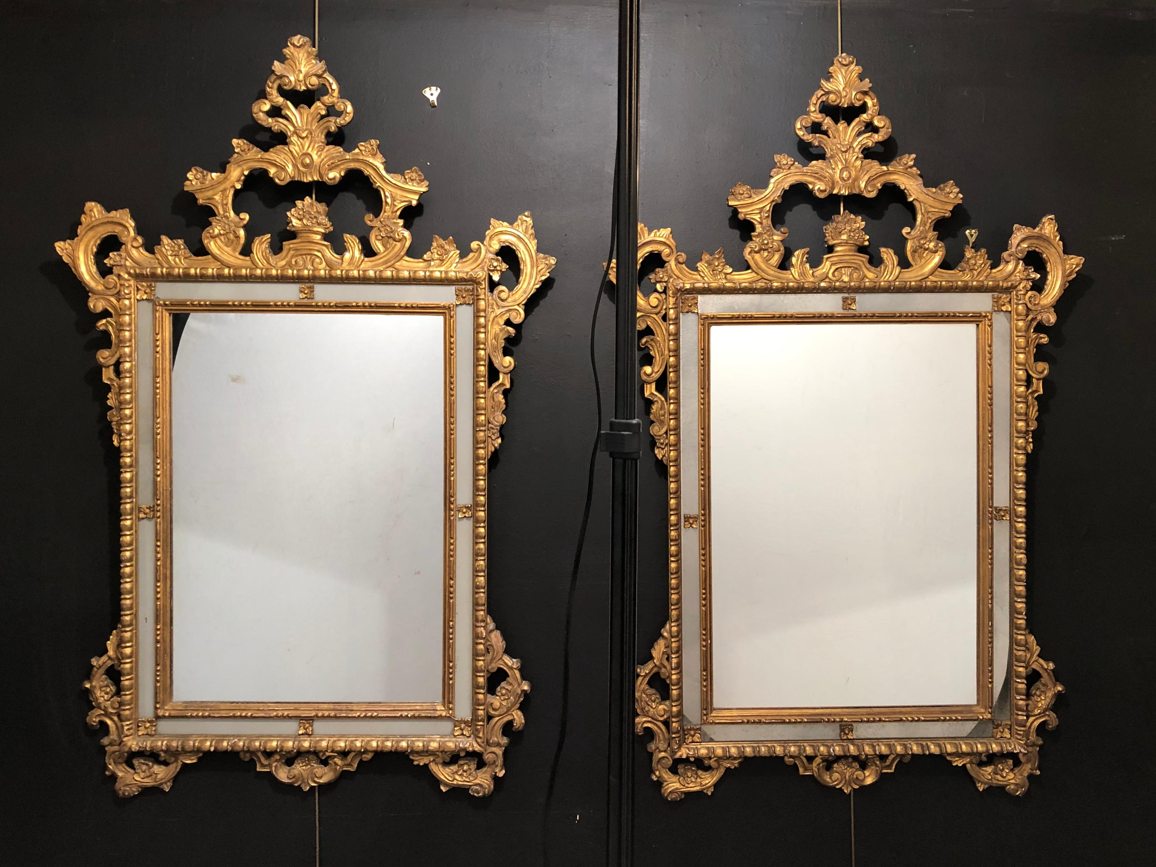 Pair of Italian giltwood wall / console mirrors. These frosted border mirrors are wonderfully carved each bearing the Fratelli Paoletti Firenze, made in Italy labels on the reverse. The outer gilt gold border is finely carved with roses, leafs,