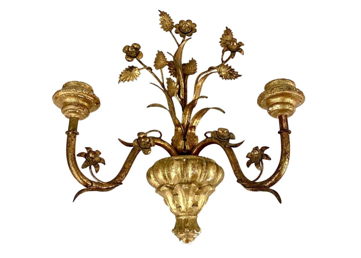 Pair of Italian giltwood and metal wall urn shaped with two armed wooden sconces. A lovely floral and leaf design decorates each sconce. Wonderful old patina.