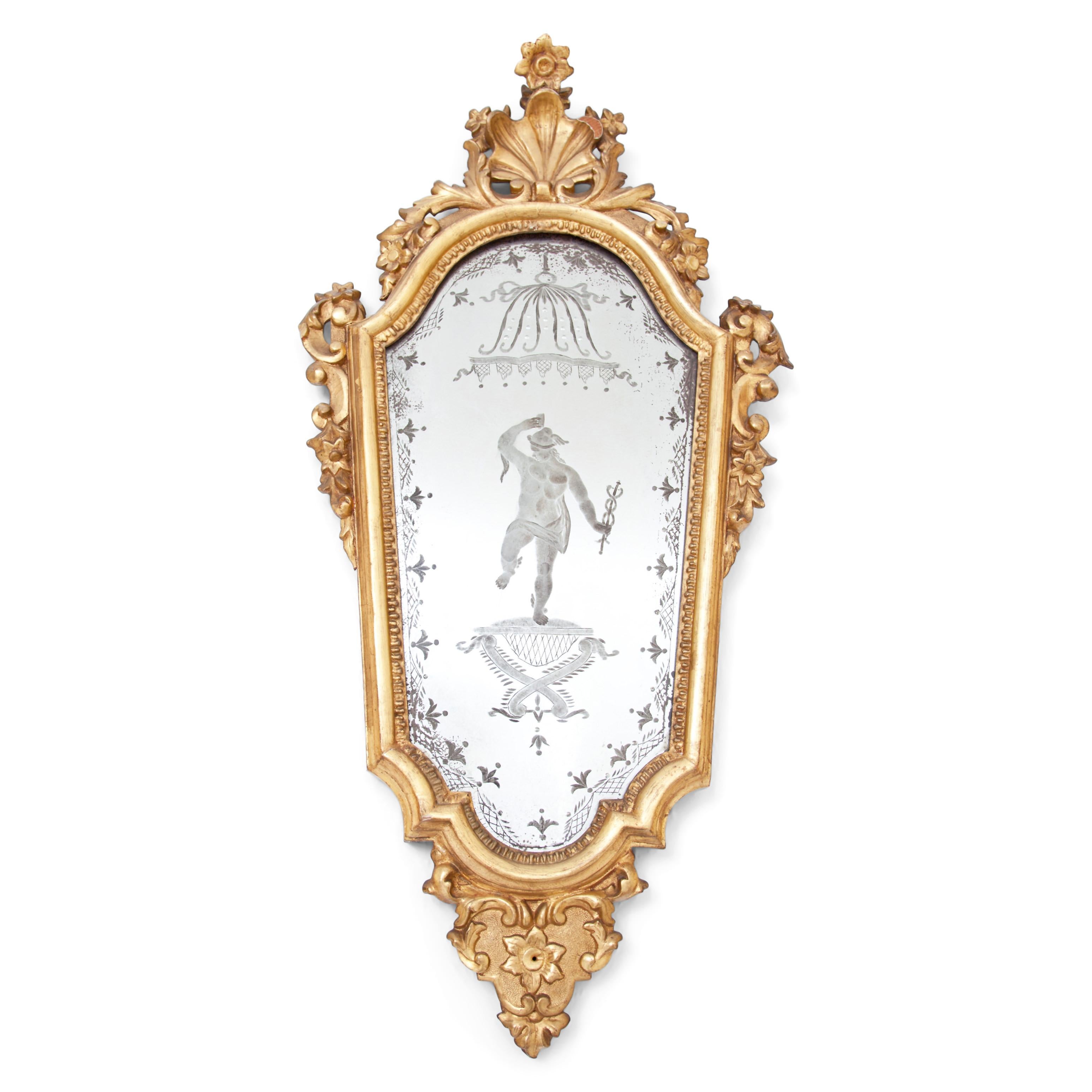 Pair of wall mirrors in gilded and stuccoed wooden frame with shell and flower decorations. The original mirror panes show carved decorations in the shape of Apollo and Nike. Gilding rubbed in places, otherwise in good condition.