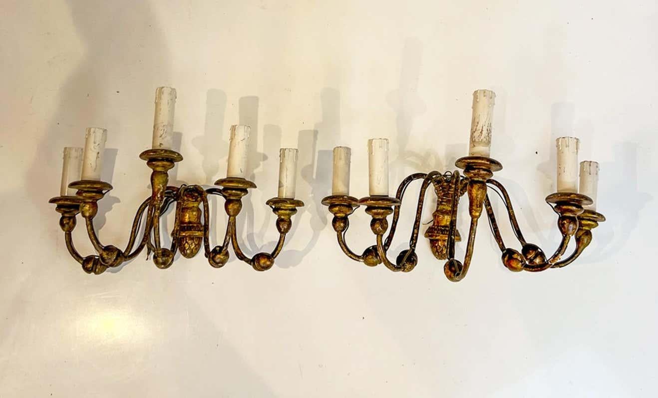 This pair of light sconces has a most unusual configuration. A semi-circular arrangement of 5 candle arms. They have been wired in Europe so would need to be re-wired for US.