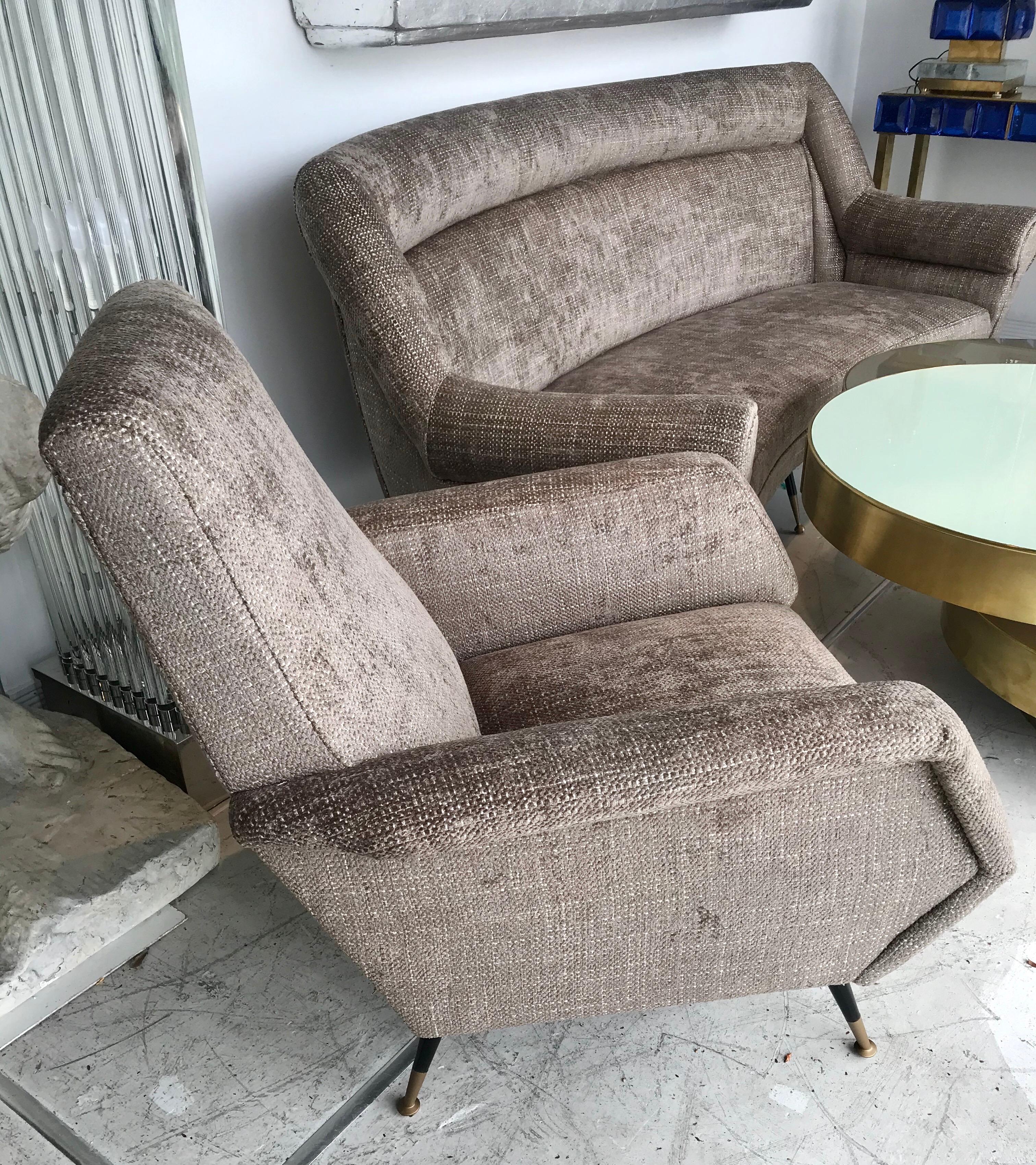 A pair of elegant Italian chaise lounge chairs in the style of Gio Ponti with beautiful taupe tweed upholstery and chic tapered legs.