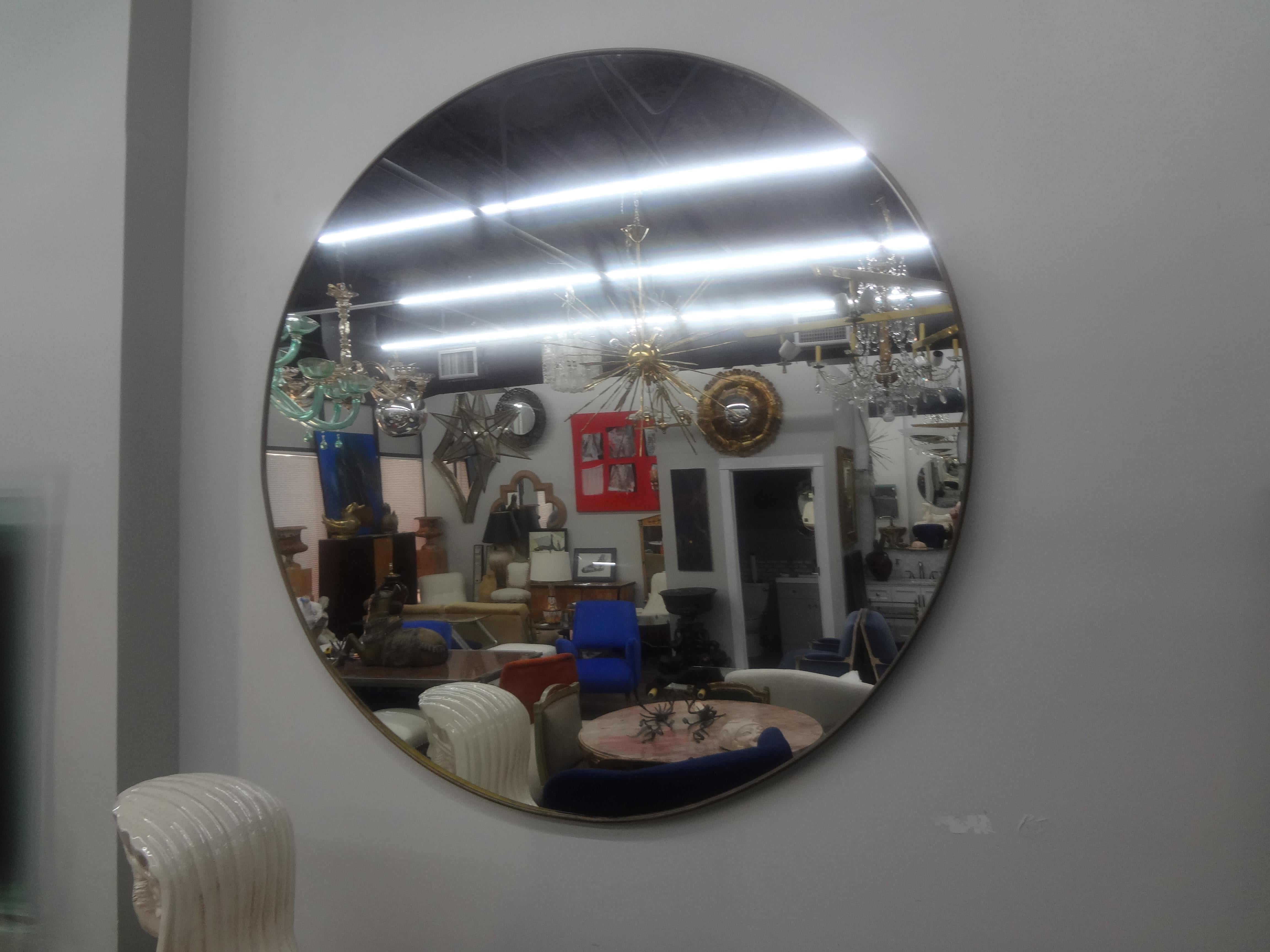 Pair Of Italian Gio Ponti Inspired Brass Mirrors.
Matching pair of Italian modernist brass or bronze mirrors have gorgeous patina and date to the 1960s. Our stunning Hollywood Regency round brass mirrors would look great over console tables,