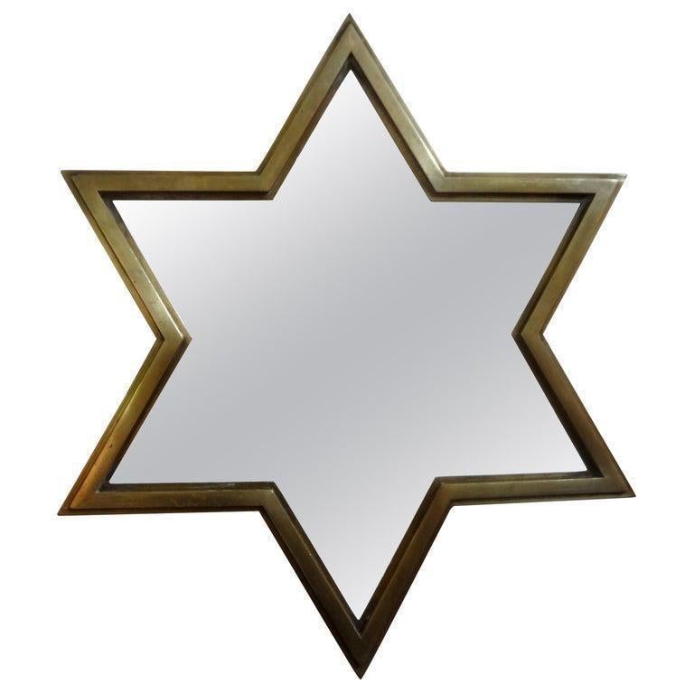 Pair Of Italian brass star shaped mirrors. Unusual pair of Italian modern Gio Ponti style star shaped brass mirrors. The depth of these Hollywood Regency Italian brass mirrors give them a three dimensional effect. These unique brass mirrors can be
