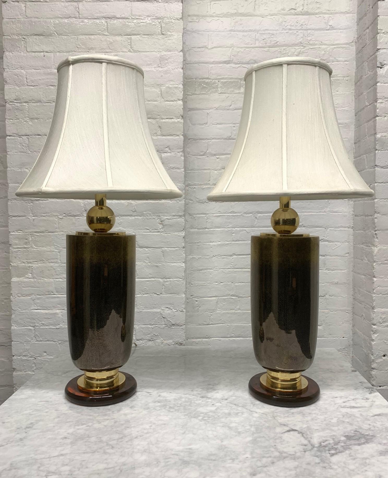 Pair of Italian glass lamps. Lamps are brass, well designed with a nice brown glass color. Also has a Bakelite base.
Shades not included.