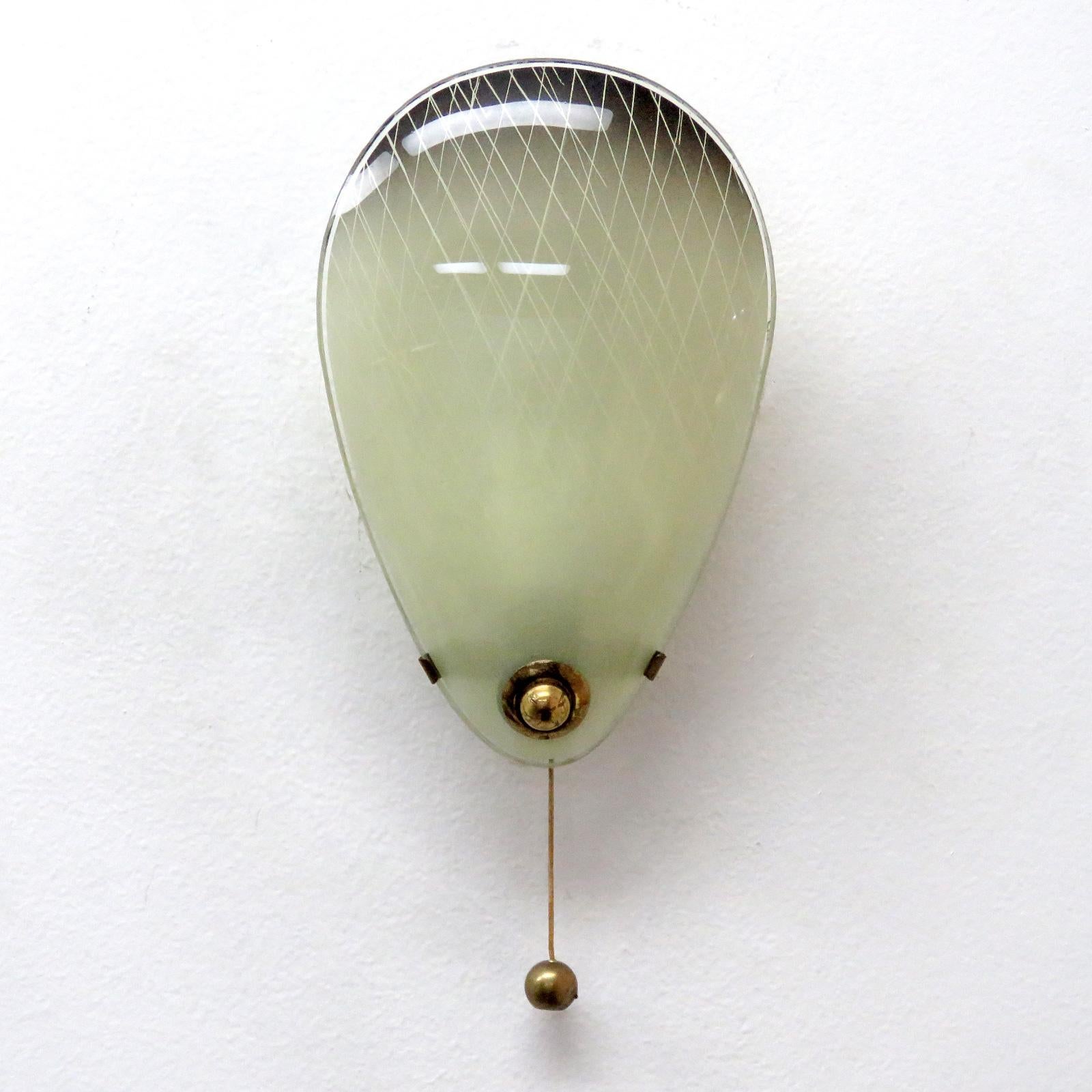 Delicate pair of petite Italian wall sconces in brass with geometrically textured, glass shields.