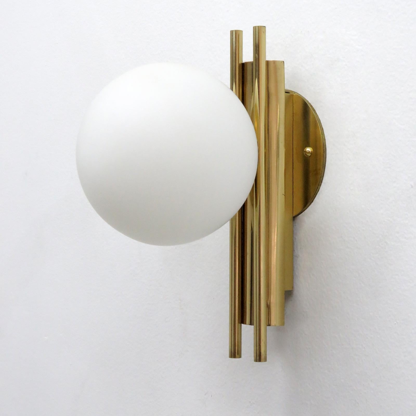 Wonderful pair of Italian wall lights in the manner of Stilnovo, in brass with matte opaline glass globes, custom solid brass back plates to cover standard US junction boxes.
