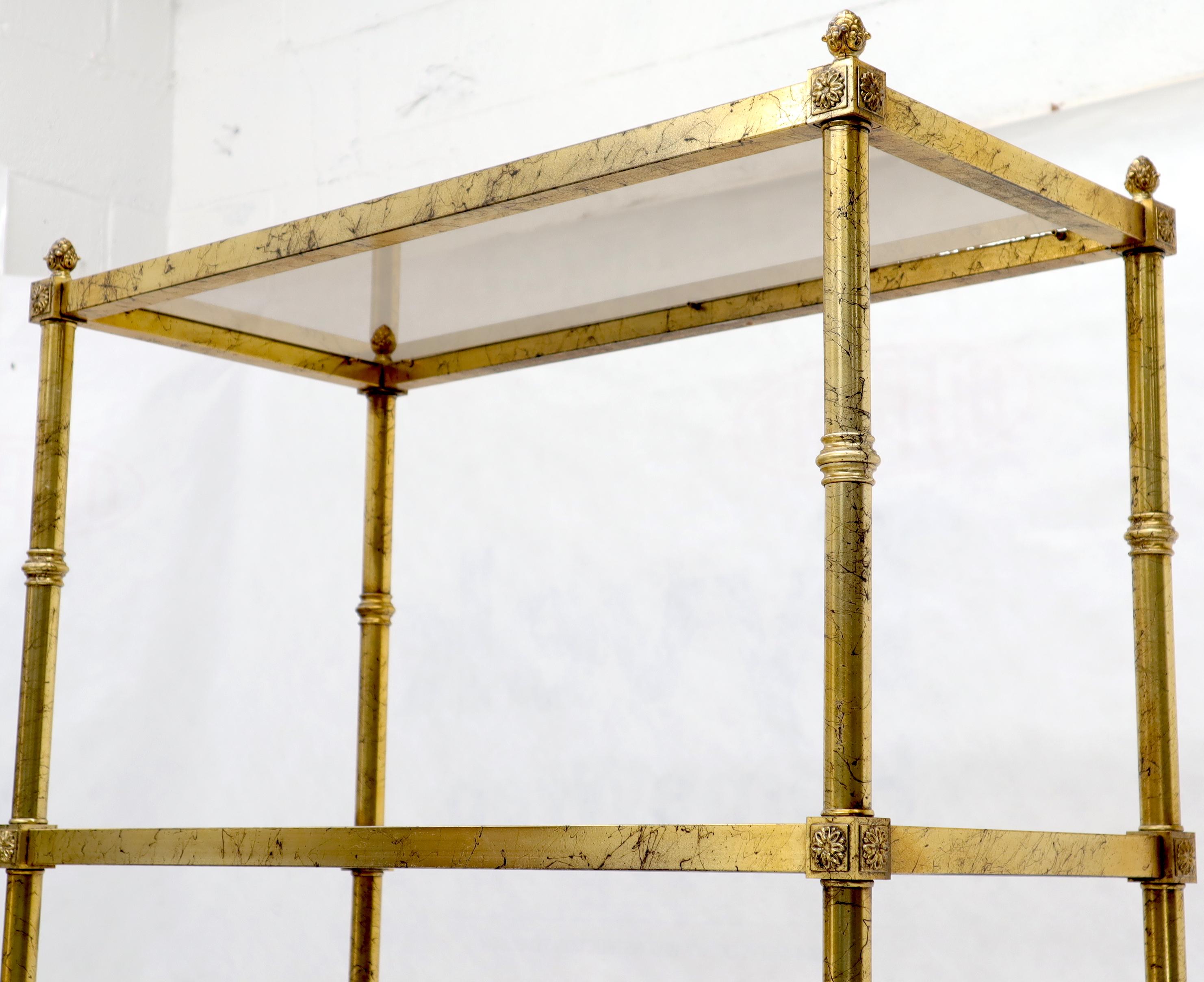 Pair of vintage Italian gold gilt smoked glass shelves étagères with pineapple finials.