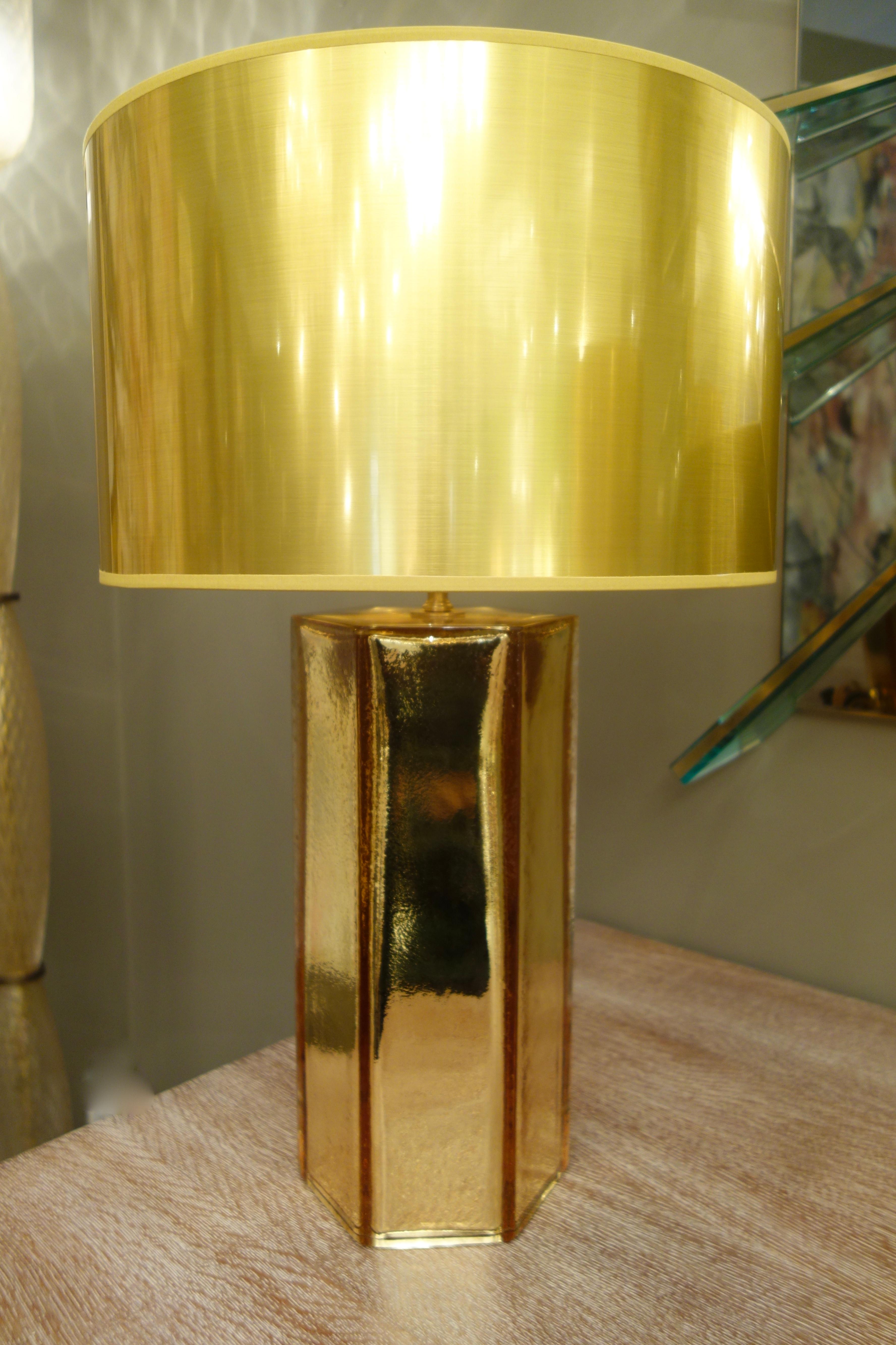A pair of Italian gold hand blown Murano mercury glass cylindrical lamps with highly reflective broad, faceted surfaces signed by master glass maker, Alberto Donà. The imported French gold custom shades are included in the price.
The height as shown