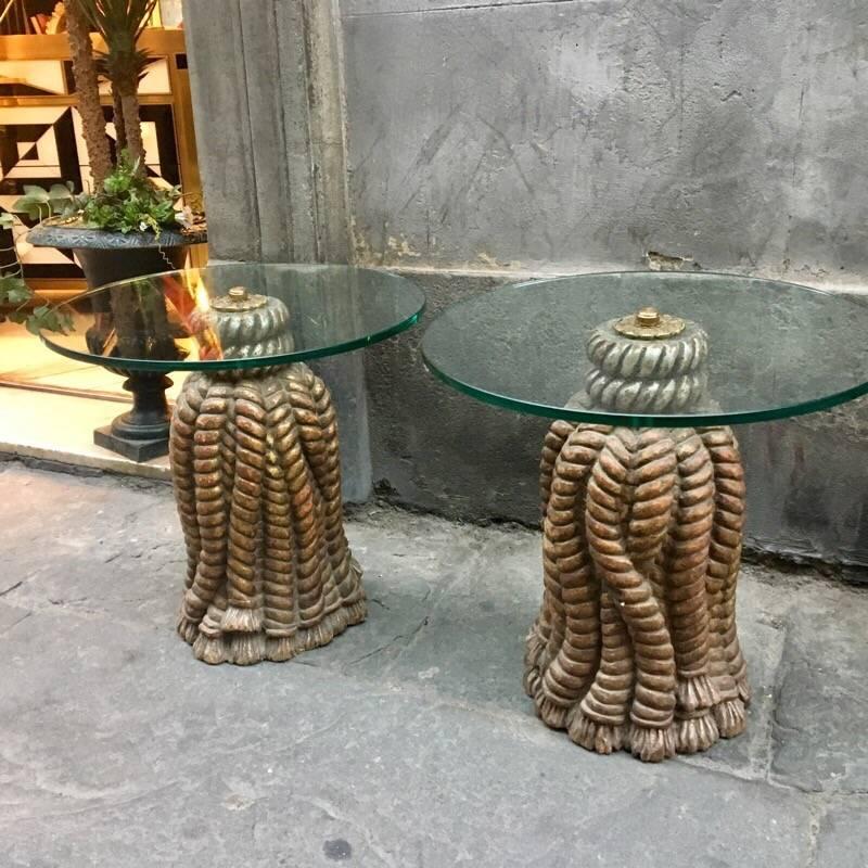 Pair of Italian golden carved wood tables, tassel shape decorated with ancient gold effect, round crystal top.
 