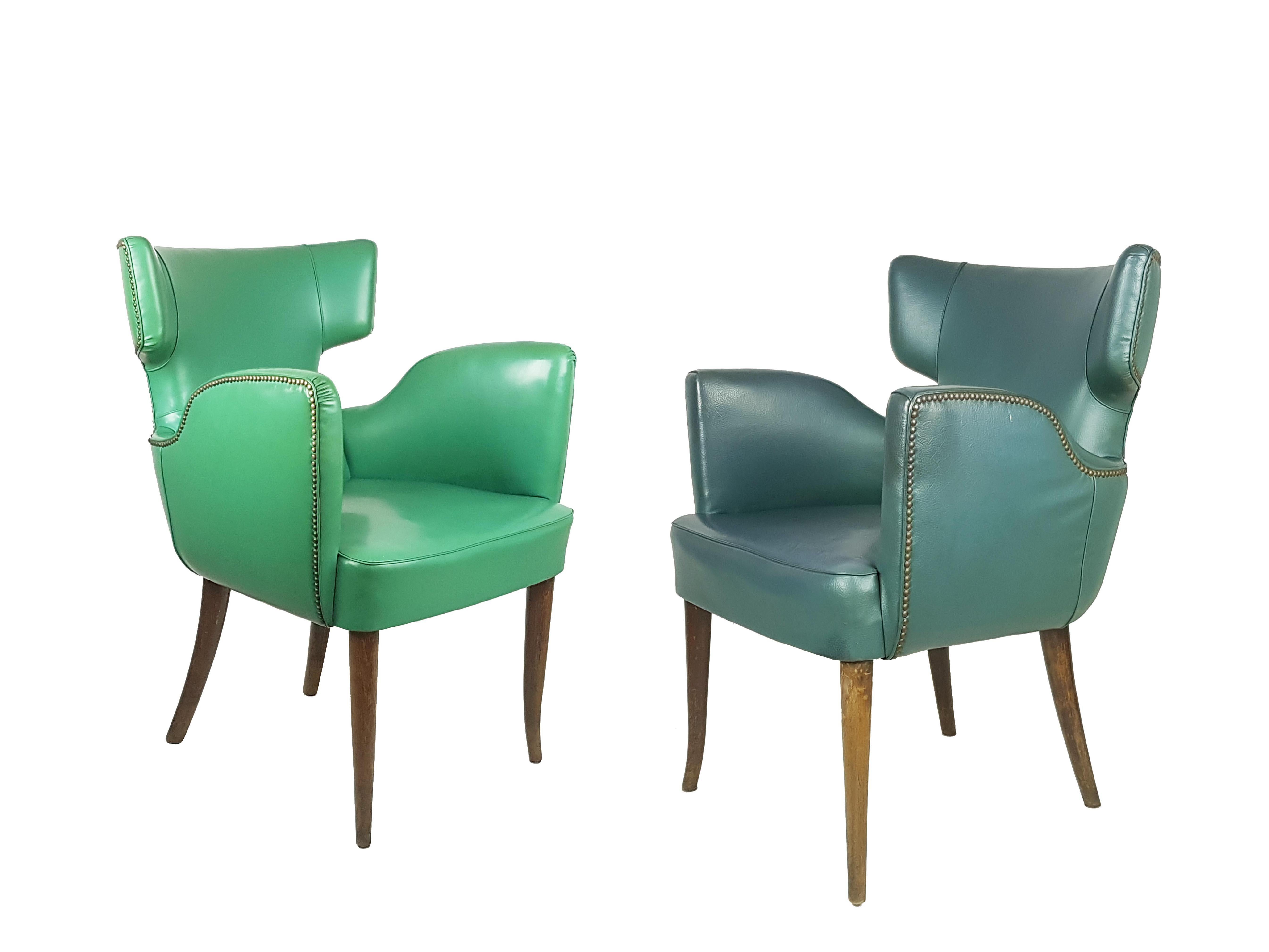 This beautiful and rare pair of light & forest green skai & wood armchair was produced in Italy in the 1950s. Its design resembles similar products by Melchiorre Bega, Paolo Buffa or Guglielmo Ulrich. Despite they belong to the same model, they have