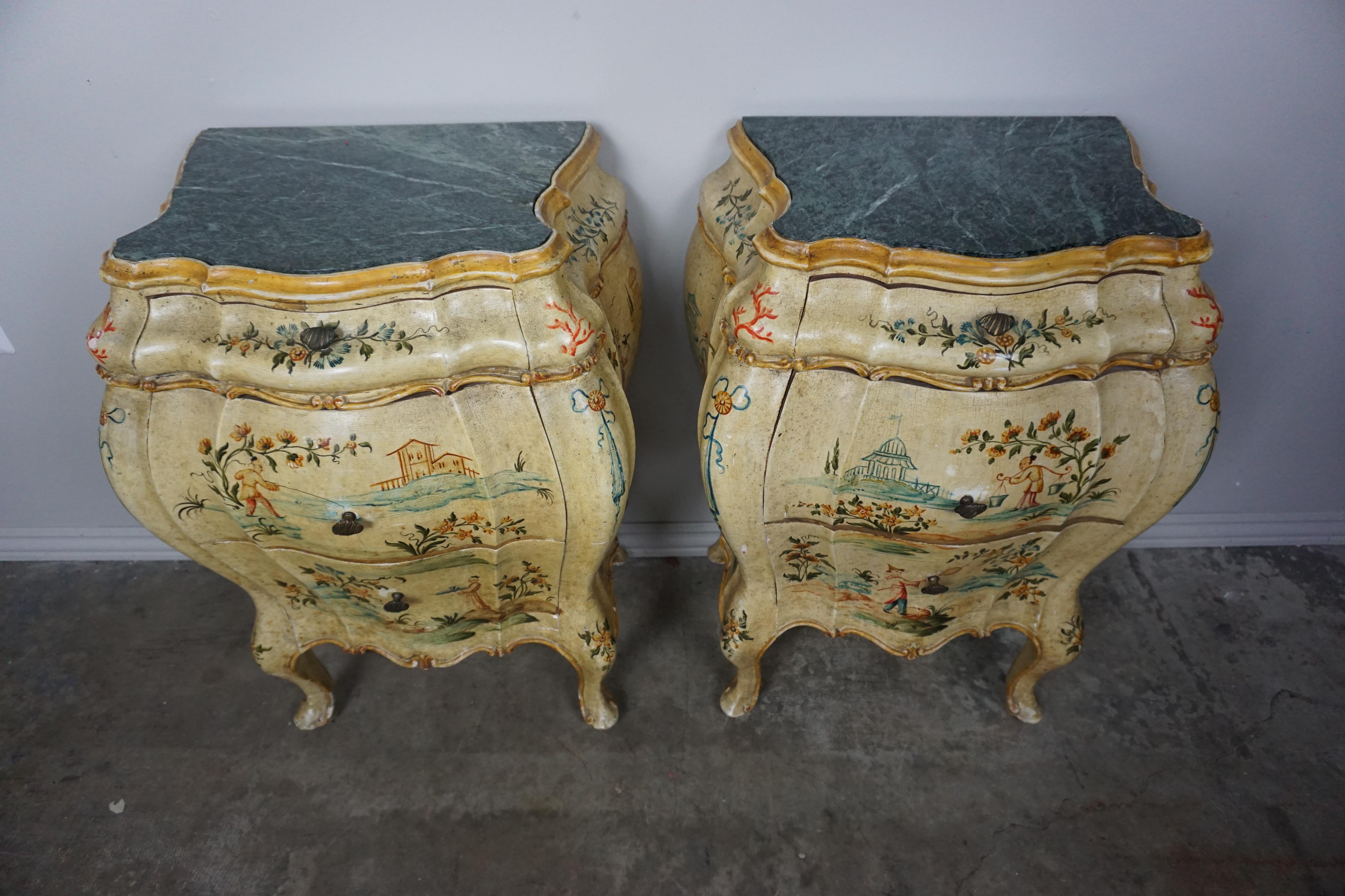 Pair of Italian hand painted chinoiserie chests with three drawers each. Detailed raised chinoiserie painted scenes throughout. Green marble inset tops. The bedside tables stand on cabriole shaped legs that end in a pad style foot.