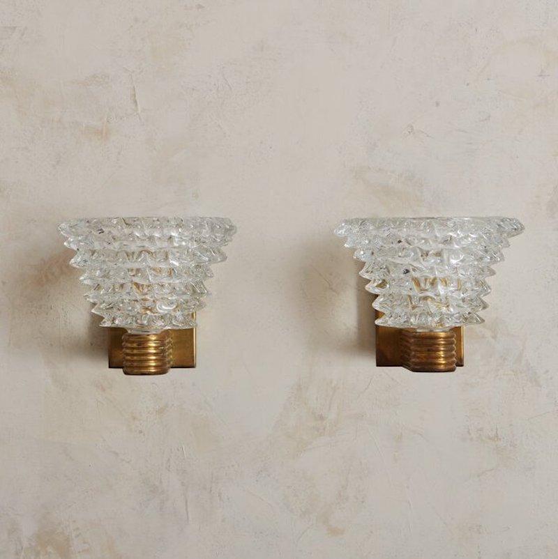 An elegant pair of hand blown glass sconces made in the likeness of the popular rostrate style that originated with Barovier and Toso. The glass sconces are vintage and mounted on contemporary brass bases with ribbed details. Each base has two small