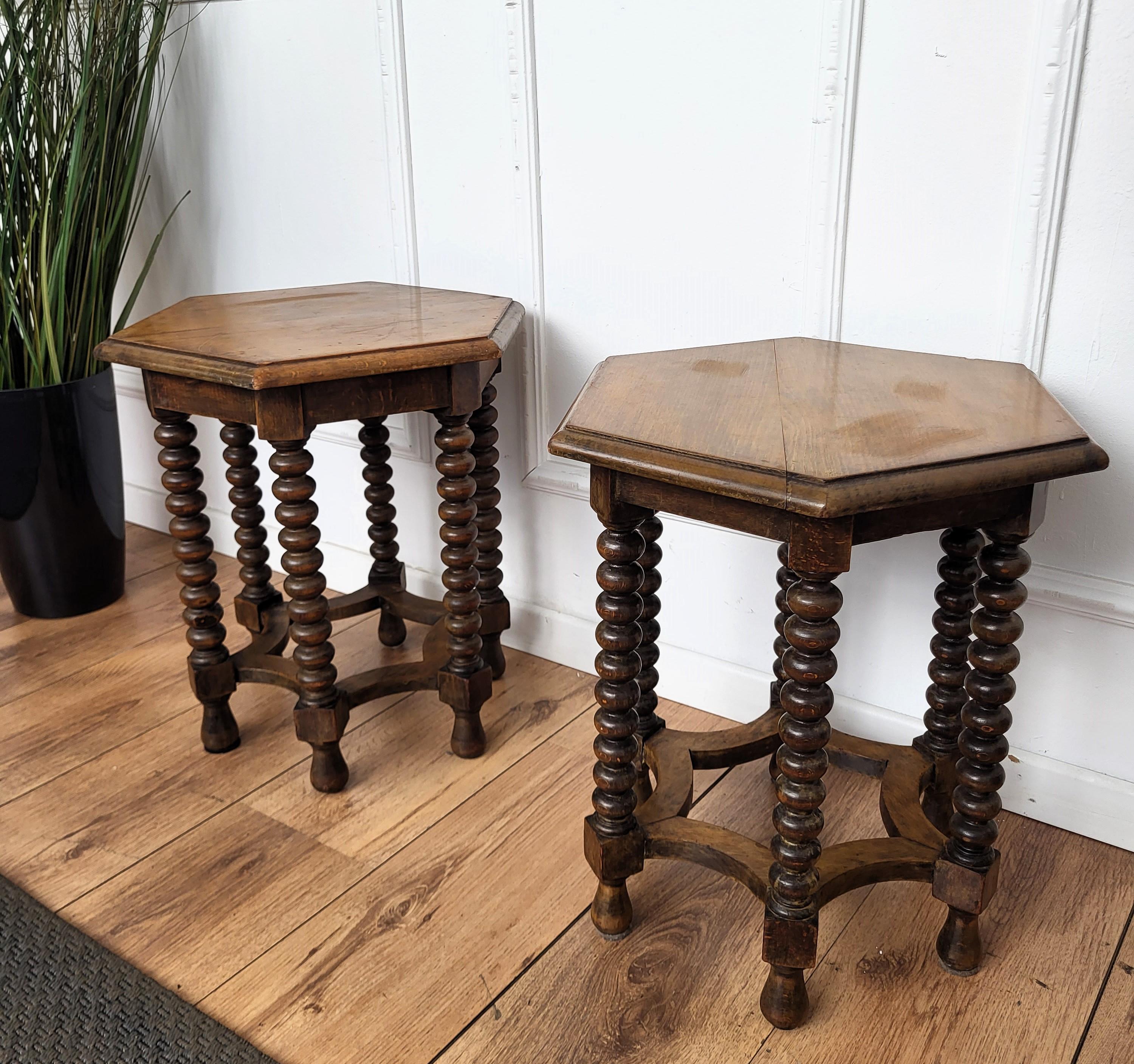Beautiful pair of antique Italian solid walnut side tables or stools featuring hexagonal top with beveled edges over six beautifully bobbin turned barley twisted legs, connected to one another with central star shaped central stretcher. This Italian